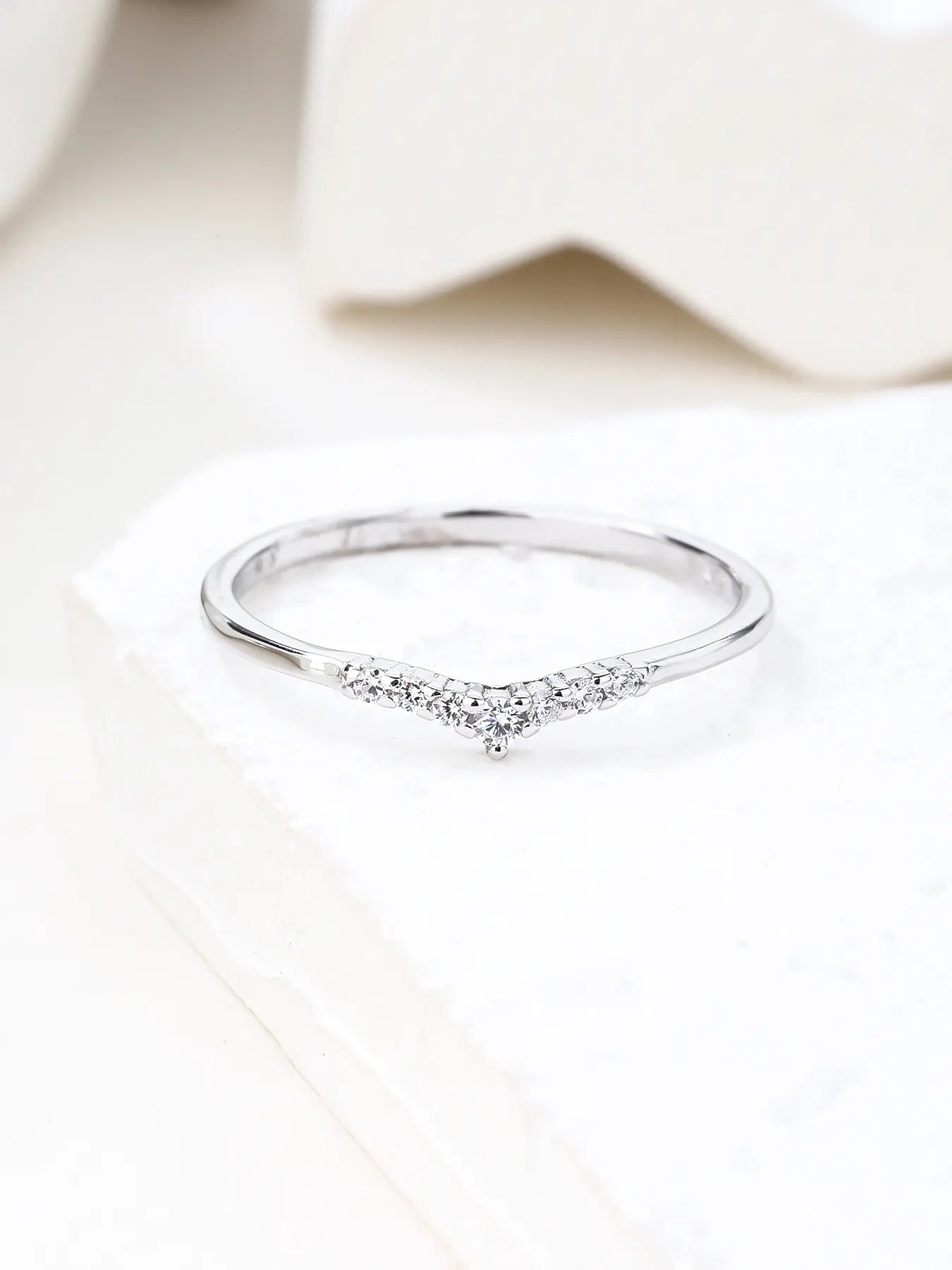 Silver ring with white cubic zirconia stones and V-shaped decoration