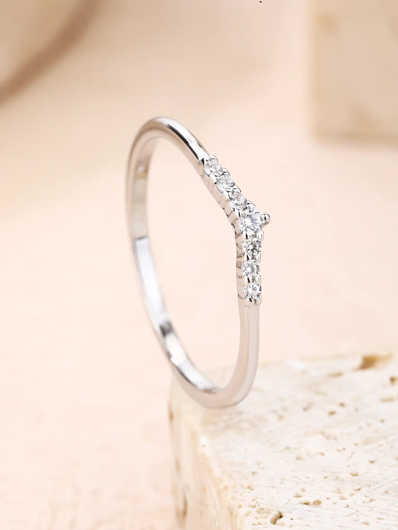 Silver ring with white cubic zirconia stones and V-shaped decoration