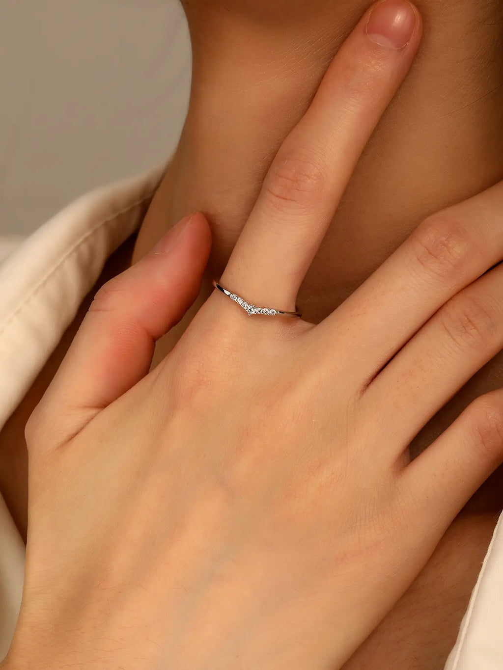Silver ring with white cubic zirconia stones and V-shaped decoration