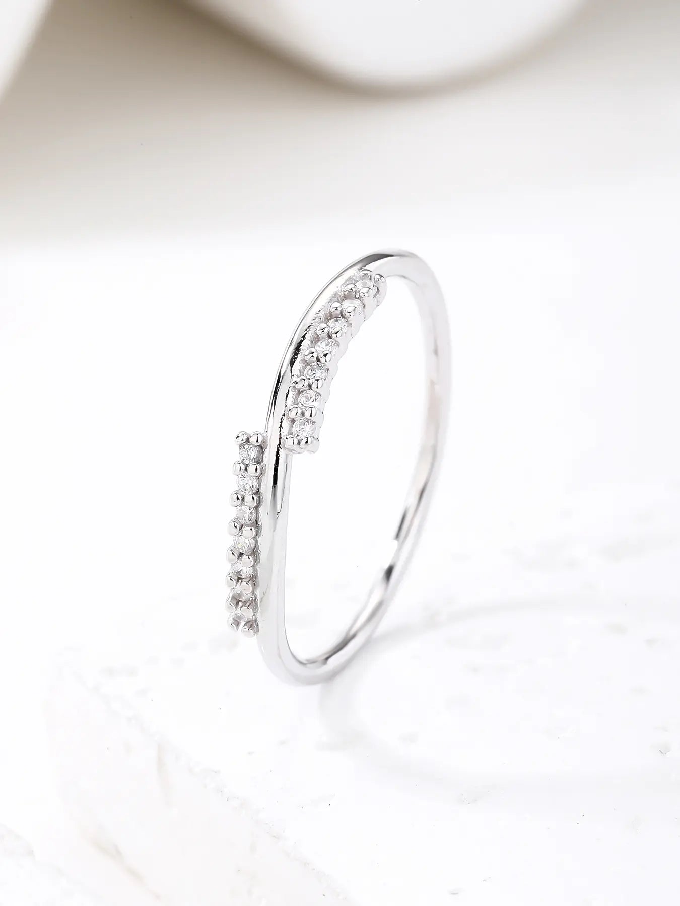 Silver ring with curved lines and zirconia decoration