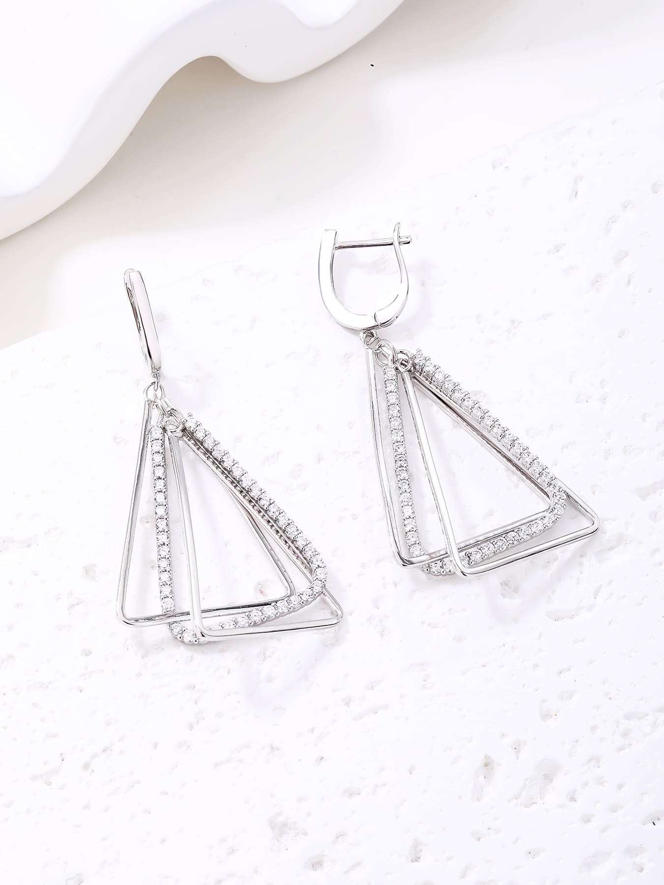 Open triangle white stone leverback earrings in hallmarked, rhodium-plated 925 sterling silver – display view – DRESCHER Jewellery®