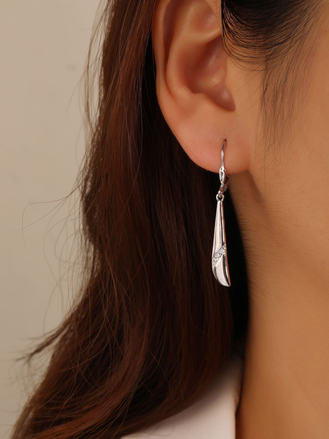 Elongated curved white cubic zirconia leverback earrings in hallmarked, rhodium-plated 925 sterling silver – worn view – DRESCHER Jewellery®