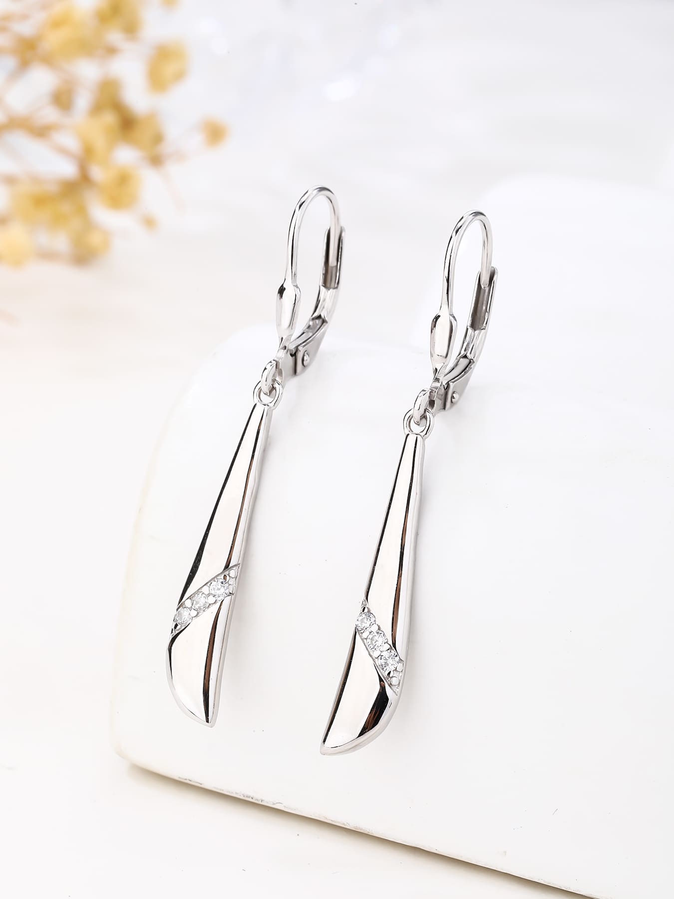Elongated curved white cubic zirconia leverback earrings in hallmarked, rhodium-plated 925 sterling silver – display view – DRESCHER Jewellery®