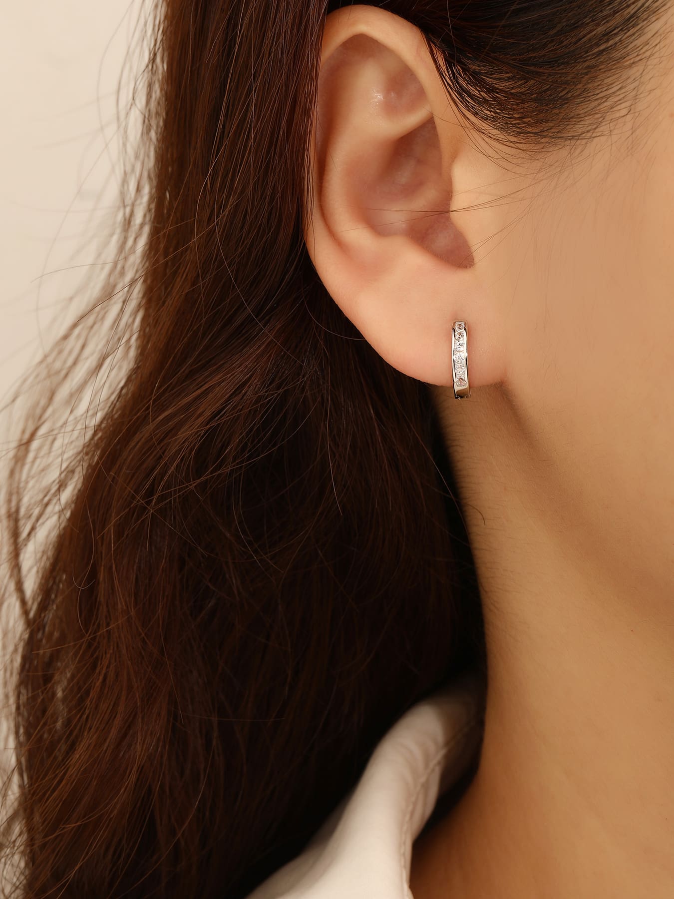 hoop earrings with white cubic zirconia stones in hallmarked, rhodium-plated 925 sterling silver – worn view – DRESCHER Jewellery®