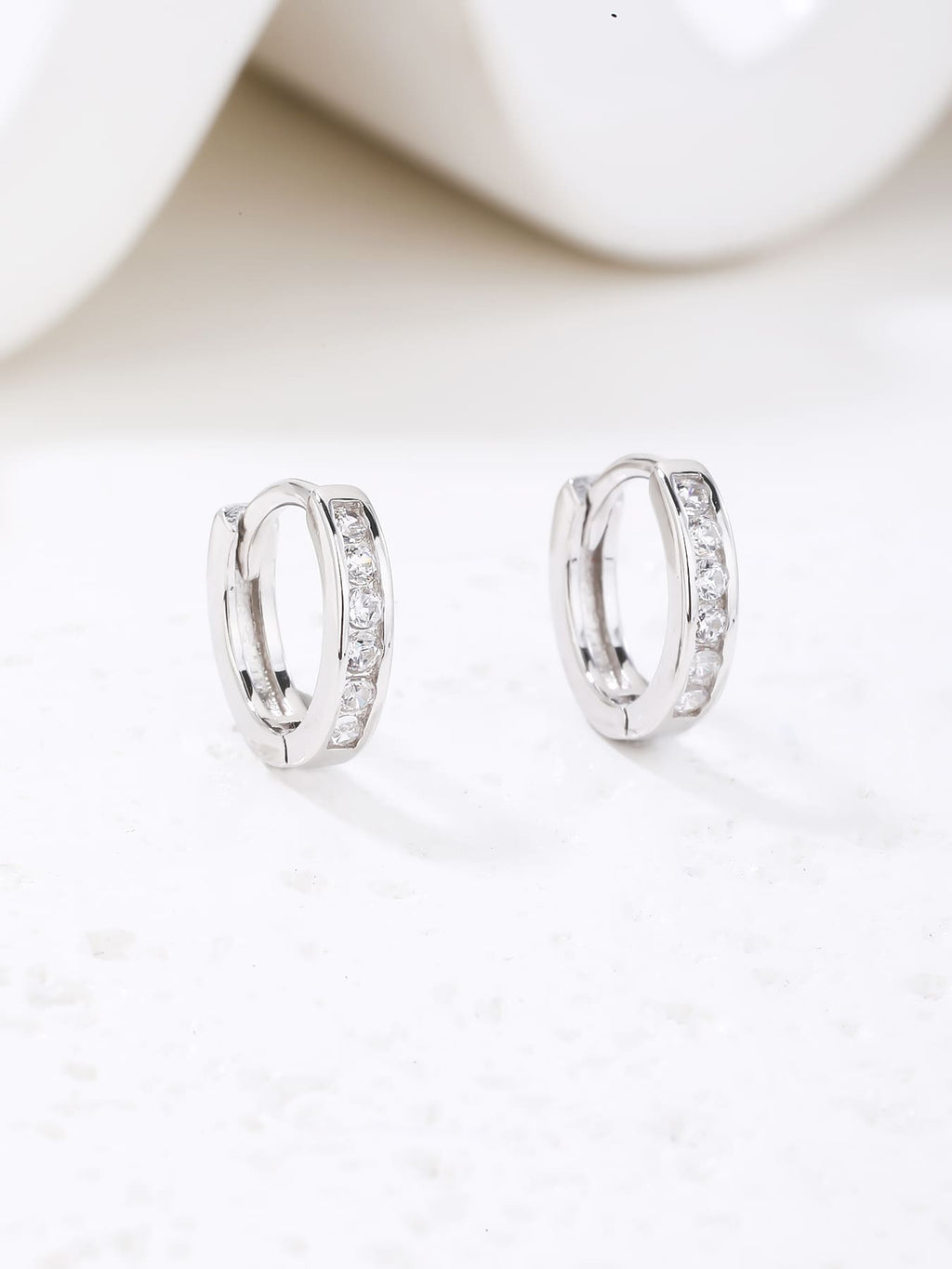 hoop earrings with white cubic zirconia stones in hallmarked, rhodium-plated 925 sterling silver – display view – DRESCHER Jewellery®