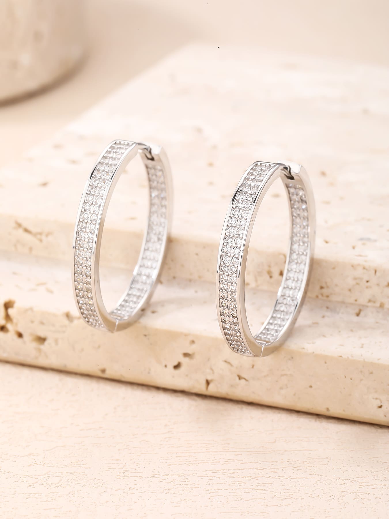 Double-row white cubic zirconia hoop earrings in hallmarked, rhodium-plated 925 sterling silver – display view – DRESCHER Jewellery®