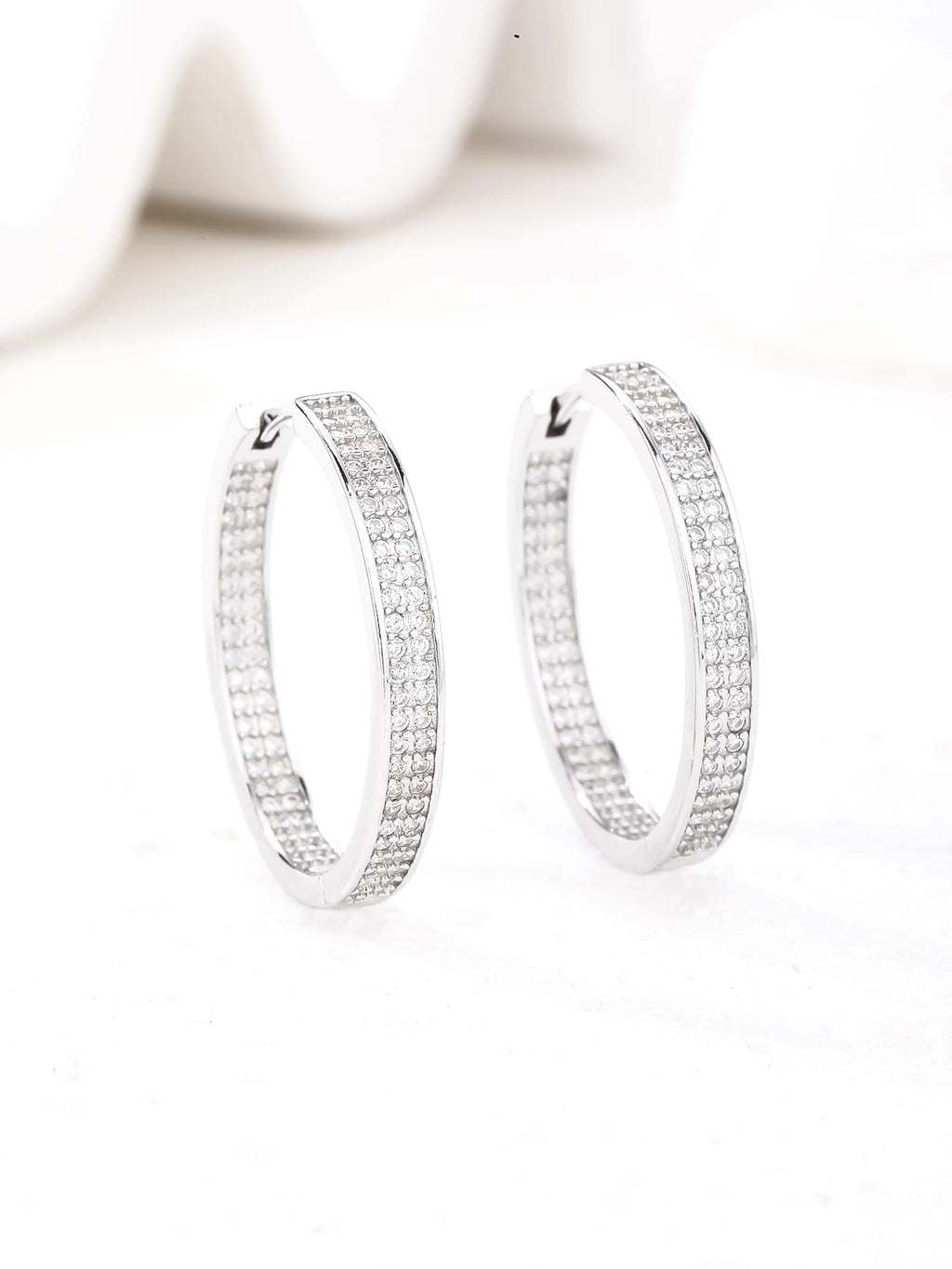 Double-row white cubic zirconia hoop earrings in hallmarked, rhodium-plated 925 sterling silver – display view – DRESCHER Jewellery®