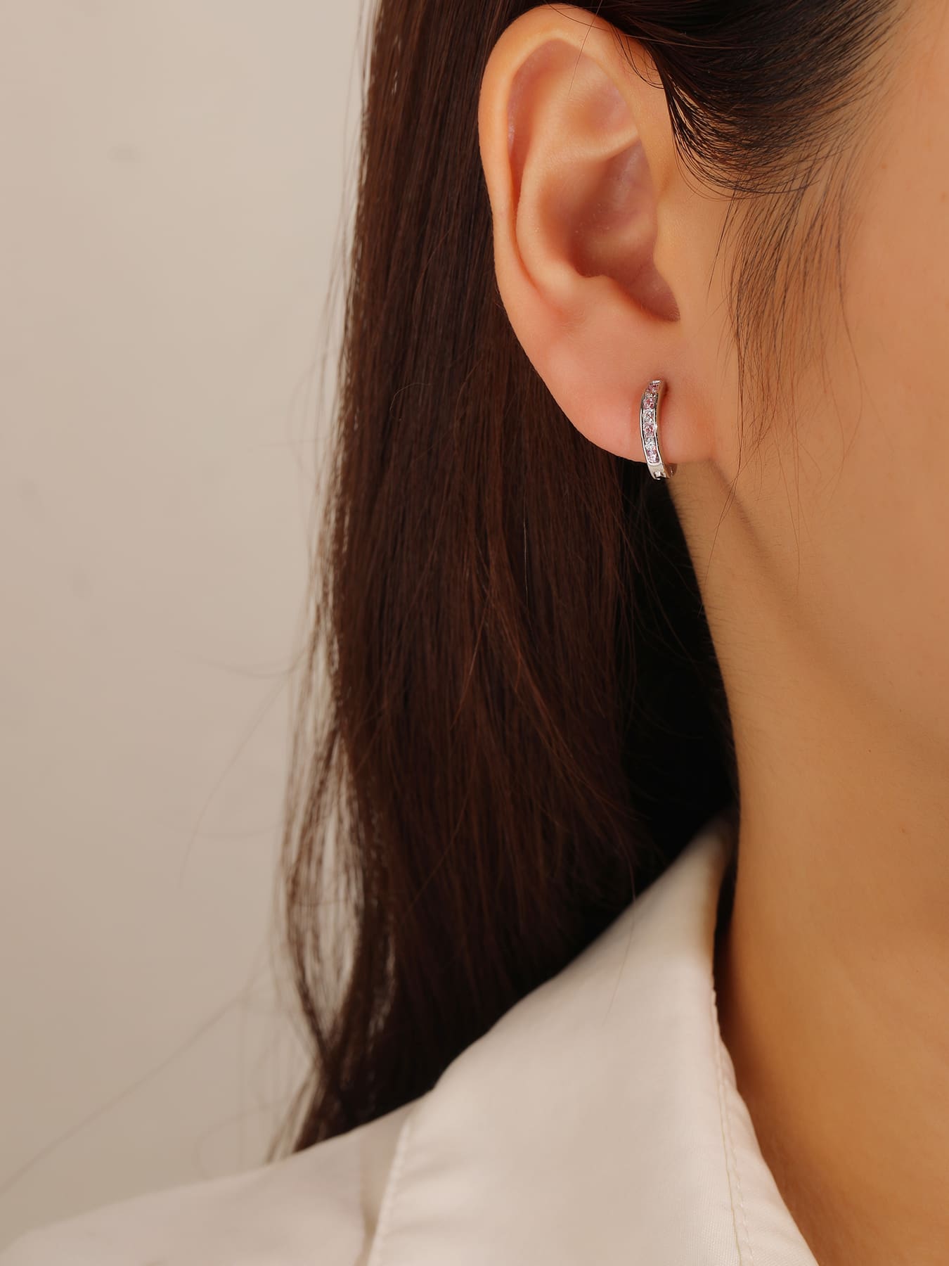 Pink and white cubic zirconia hoop earrings in hallmarked, rhodium-plated 925 sterling silver – worn view – DRESCHER Jewellery®