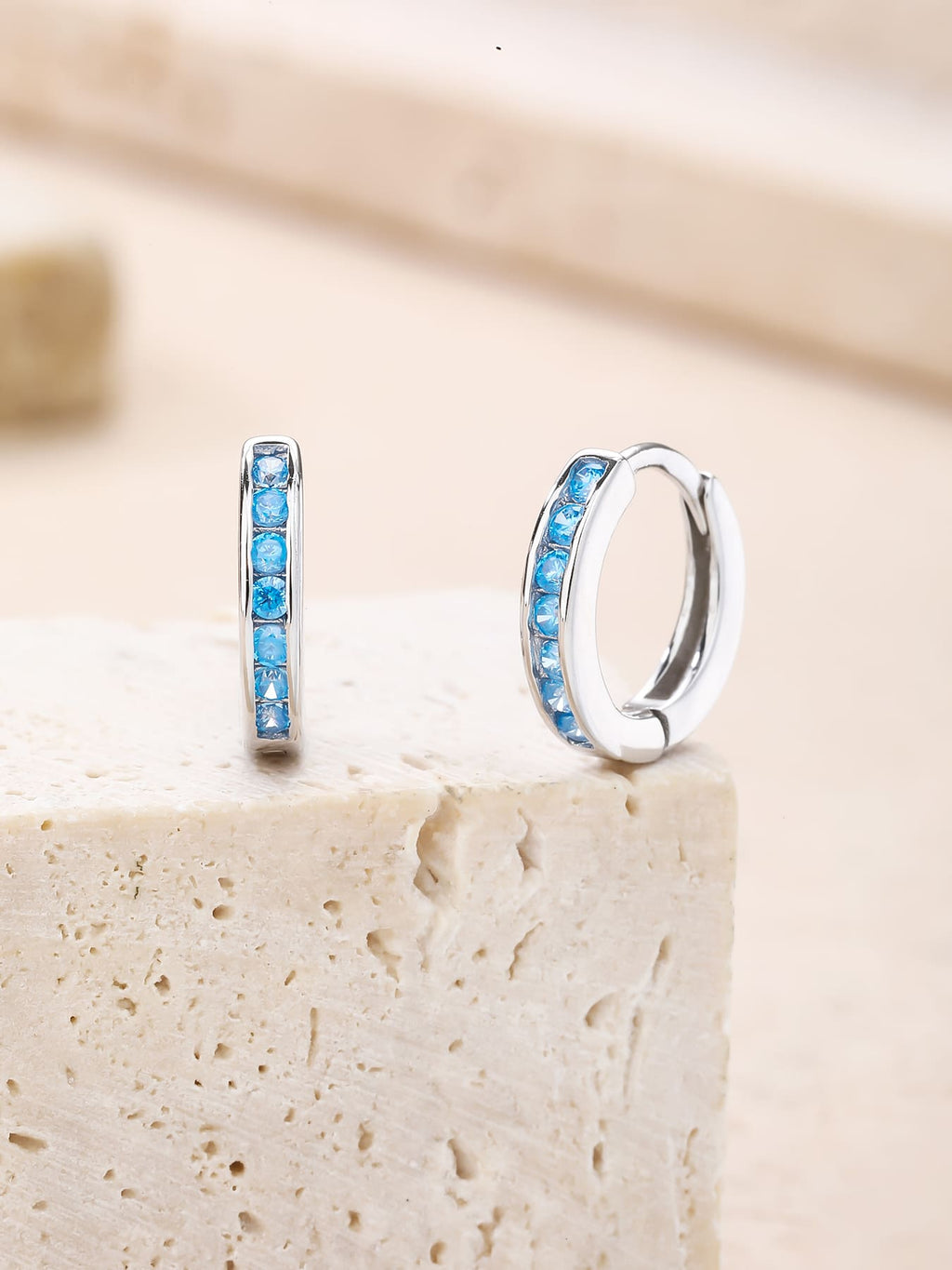 Light blue cubic zirconia hoop earrings in hallmarked, rhodium-plated 925 sterling silver – lifestyle view – DRESCHER Jewellery®