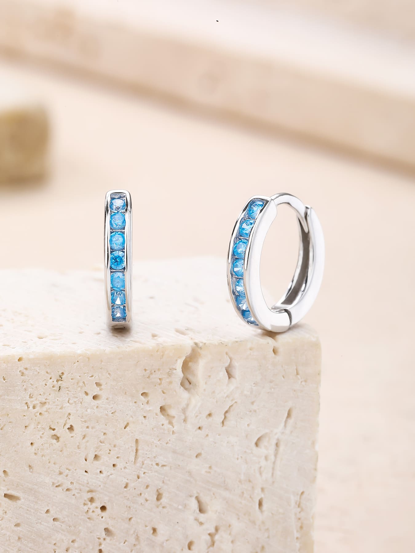 Light blue cubic zirconia hoop earrings in hallmarked, rhodium-plated 925 sterling silver – lifestyle view – DRESCHER Jewellery®