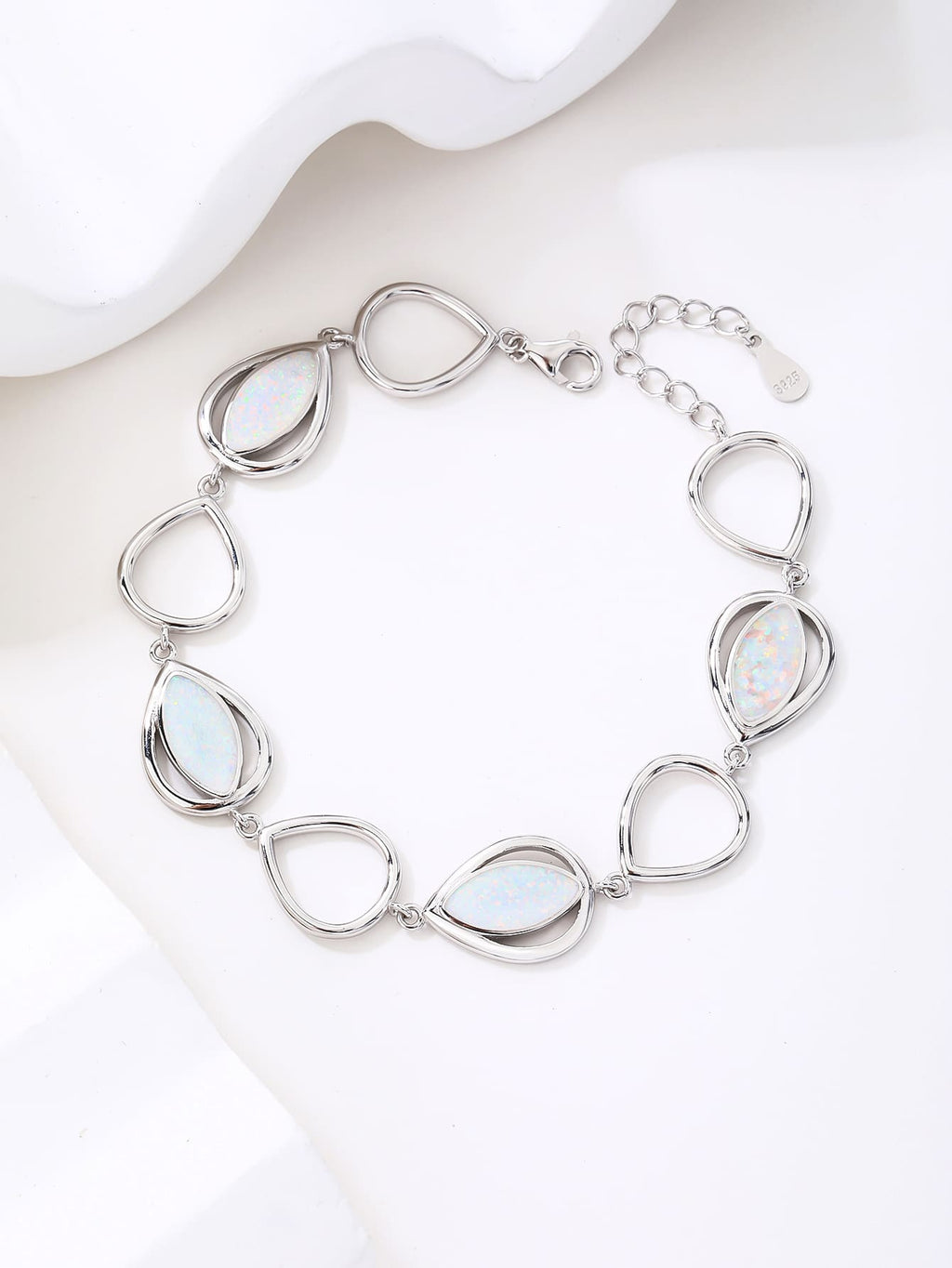 bracelet with drop outline and white opal stones (16,5+3,5 cm) in hallmarked, rhodium-plated 925 sterling silver – lifestyle view – DRESCHER Jewellery®