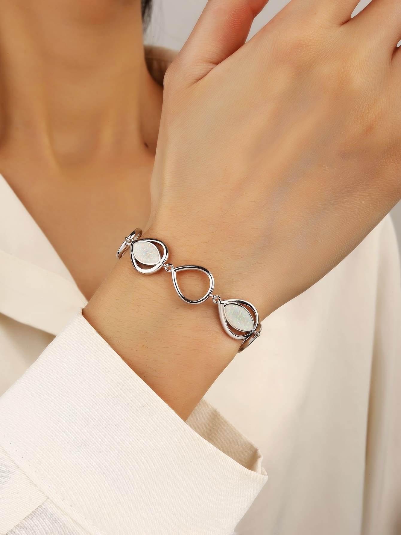 bracelet with drop outline and white opal stones (16,5+3,5 cm) in hallmarked, rhodium-plated 925 sterling silver – worn view – DRESCHER Jewellery®