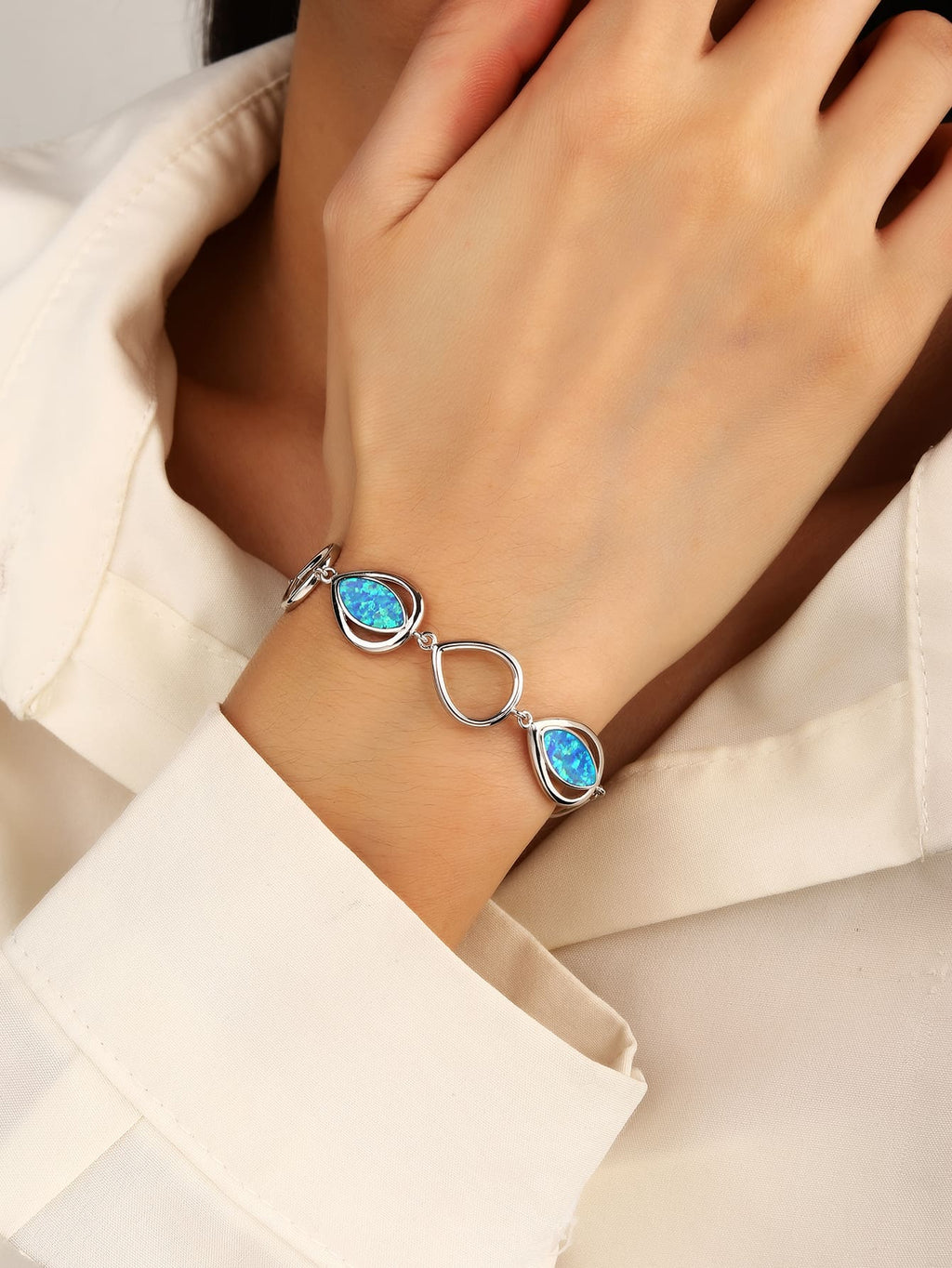 bracelet with drop outline and blue opal stones (16,5+3,5 cm) in hallmarked, rhodium-plated 925 sterling silver – worn view – DRESCHER Jewellery®