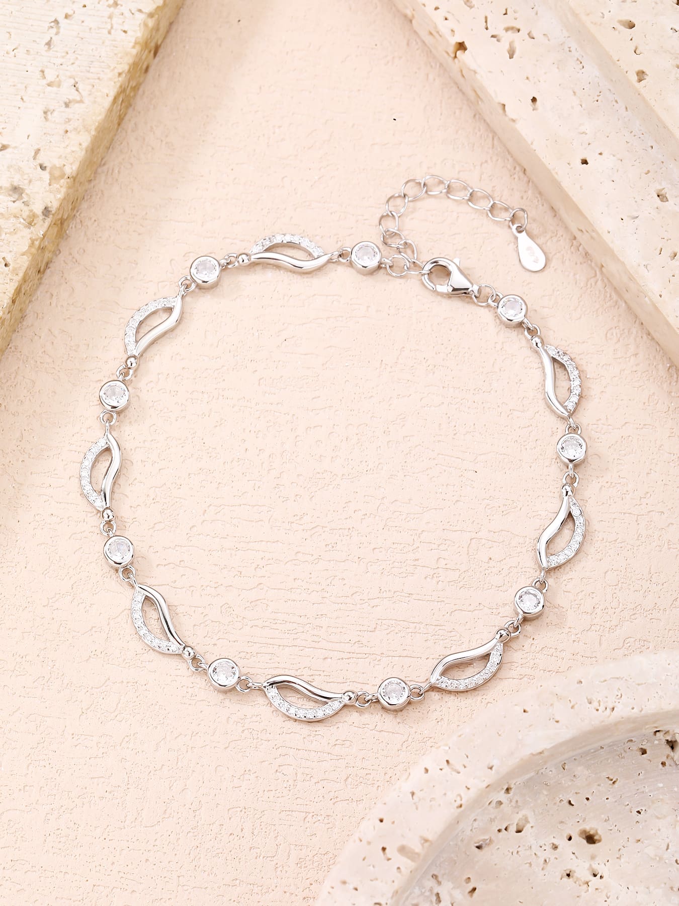 bracelet with wave shaped zirconia decoration in hallmarked, rhodium-plated 925 sterling silver – worn view – DRESCHER Jewellery®
