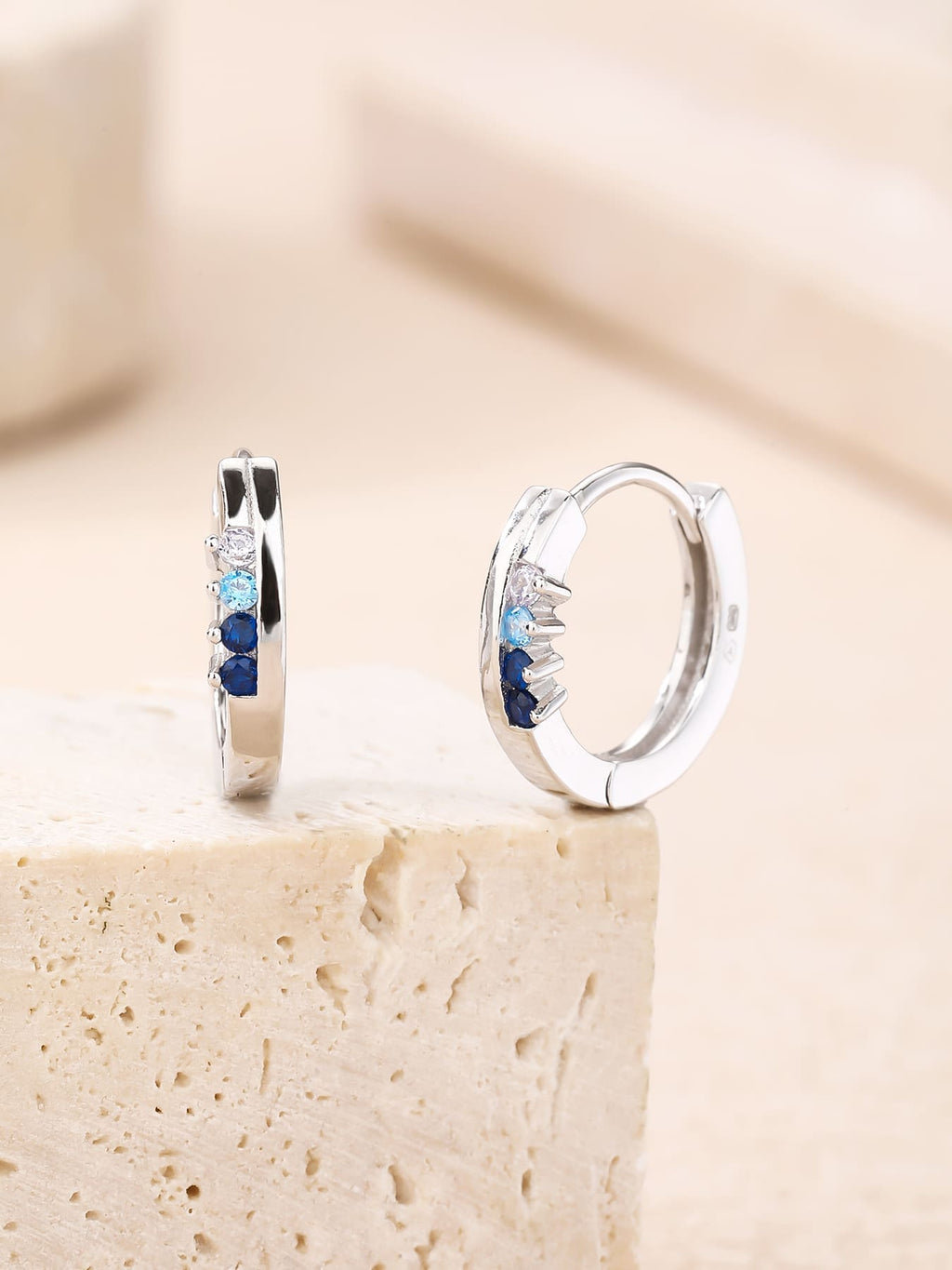 Blue, light blue and white cubic zirconia hoop earrings in hallmarked, rhodium-plated 925 sterling silver – display view – DRESCHER Jewellery®