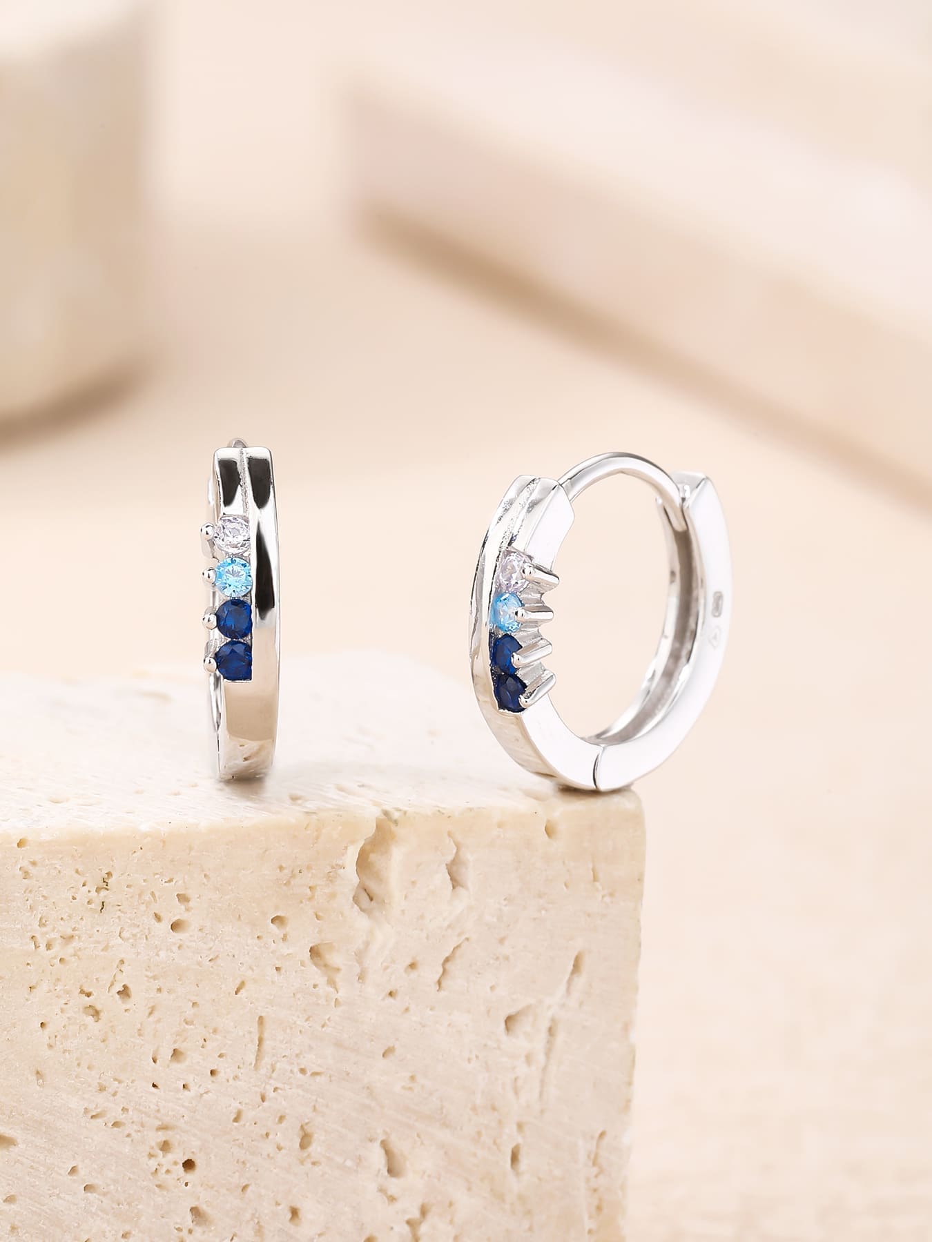 Blue, light blue and white cubic zirconia hoop earrings in hallmarked, rhodium-plated 925 sterling silver – display view – DRESCHER Jewellery®