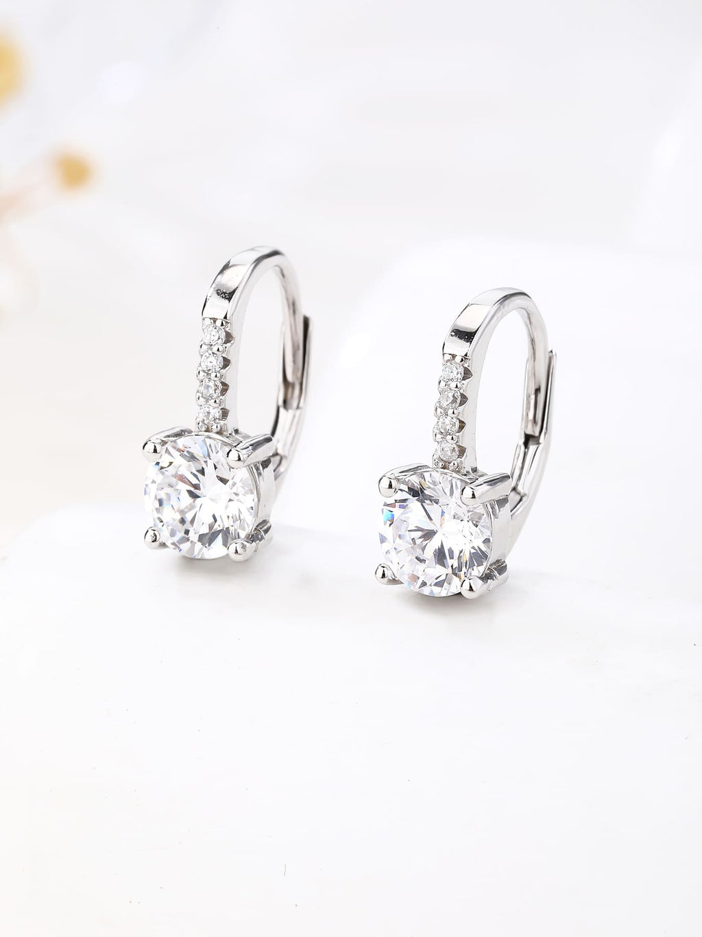 round cubic zirconia stone earrings with patent closure in hallmarked, rhodium-plated 925 sterling silver – lifestyle view – DRESCHER Jewellery®