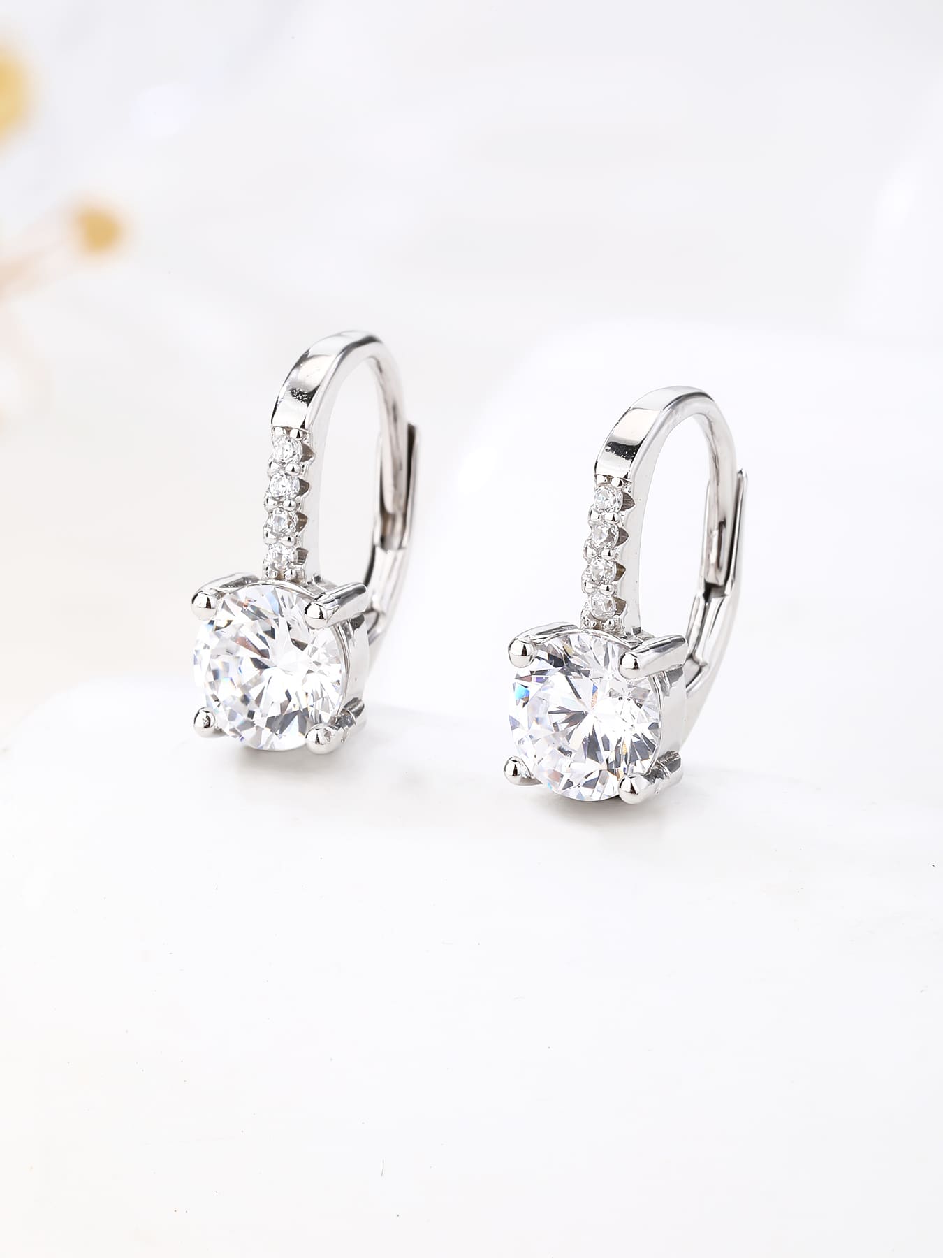 round cubic zirconia stone earrings with patent closure in hallmarked, rhodium-plated 925 sterling silver – lifestyle view – DRESCHER Jewellery®