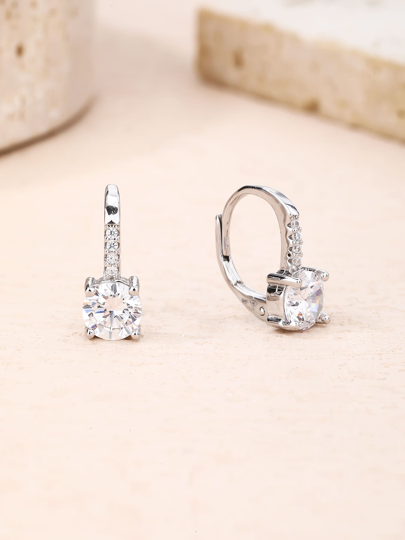 round cubic zirconia stone earrings with patent closure in hallmarked, rhodium-plated 925 sterling silver – worn view – DRESCHER Jewellery®