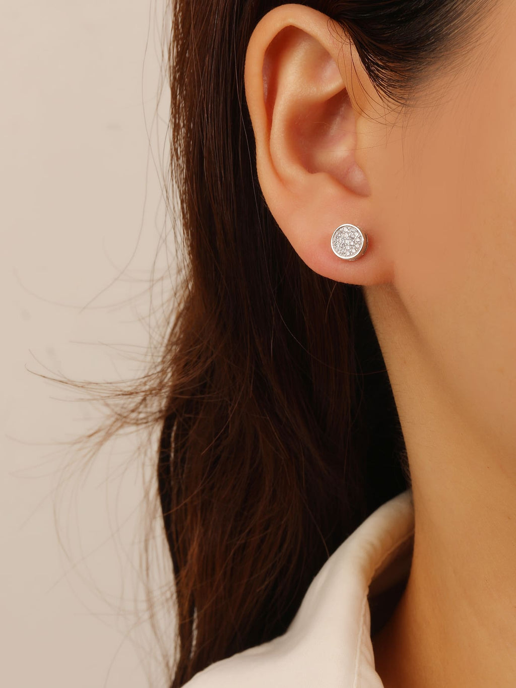 Round pavé white cubic zirconia stud earrings in hallmarked, rhodium-plated 925 sterling silver – worn view – DRESCHER Jewellery®