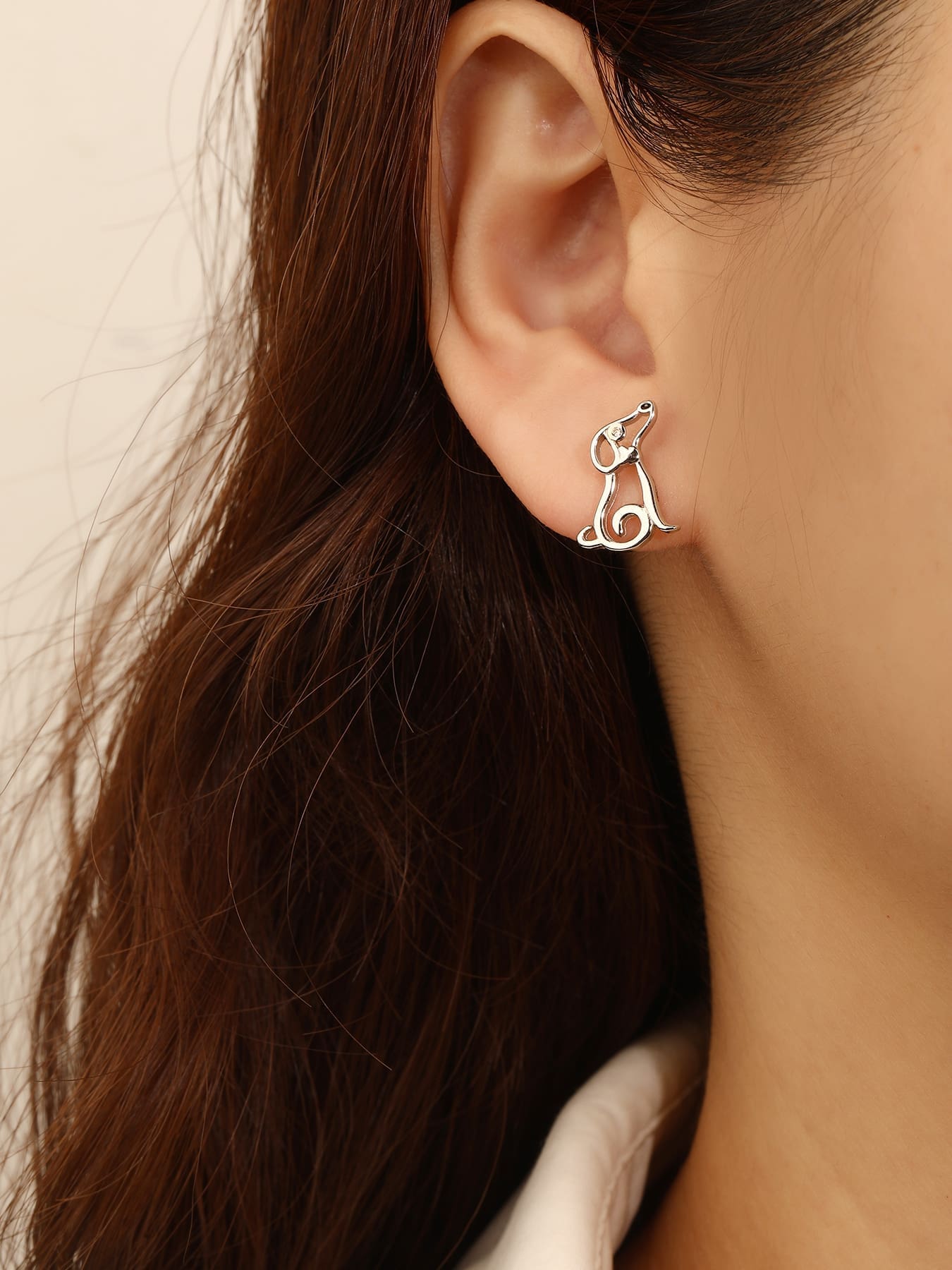 Dog-shaped stud earrings with cubic zirconia eyes in hallmarked, rhodium-plated 925 sterling silver – worn view – DRESCHER Jewellery®