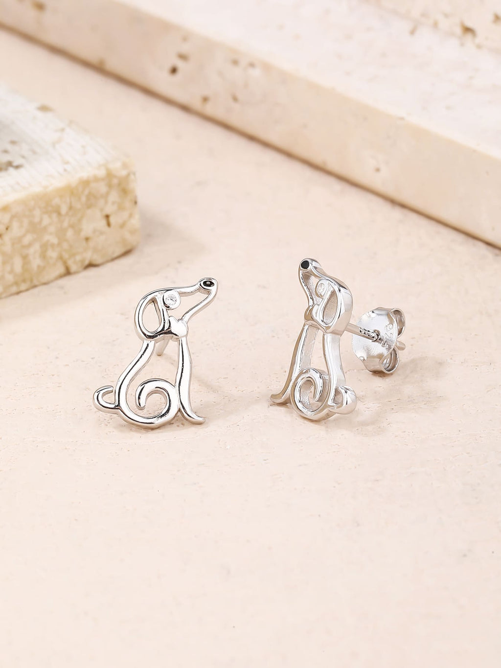 Dog-shaped stud earrings with cubic zirconia eyes in hallmarked, rhodium-plated 925 sterling silver – display view – DRESCHER Jewellery®