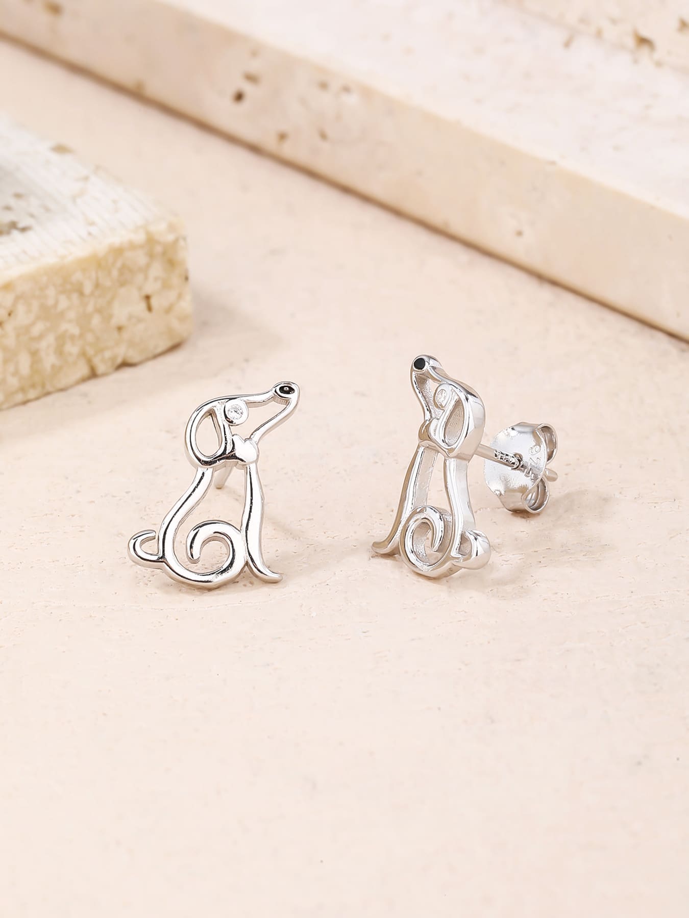 Dog-shaped stud earrings with cubic zirconia eyes in hallmarked, rhodium-plated 925 sterling silver – display view – DRESCHER Jewellery®