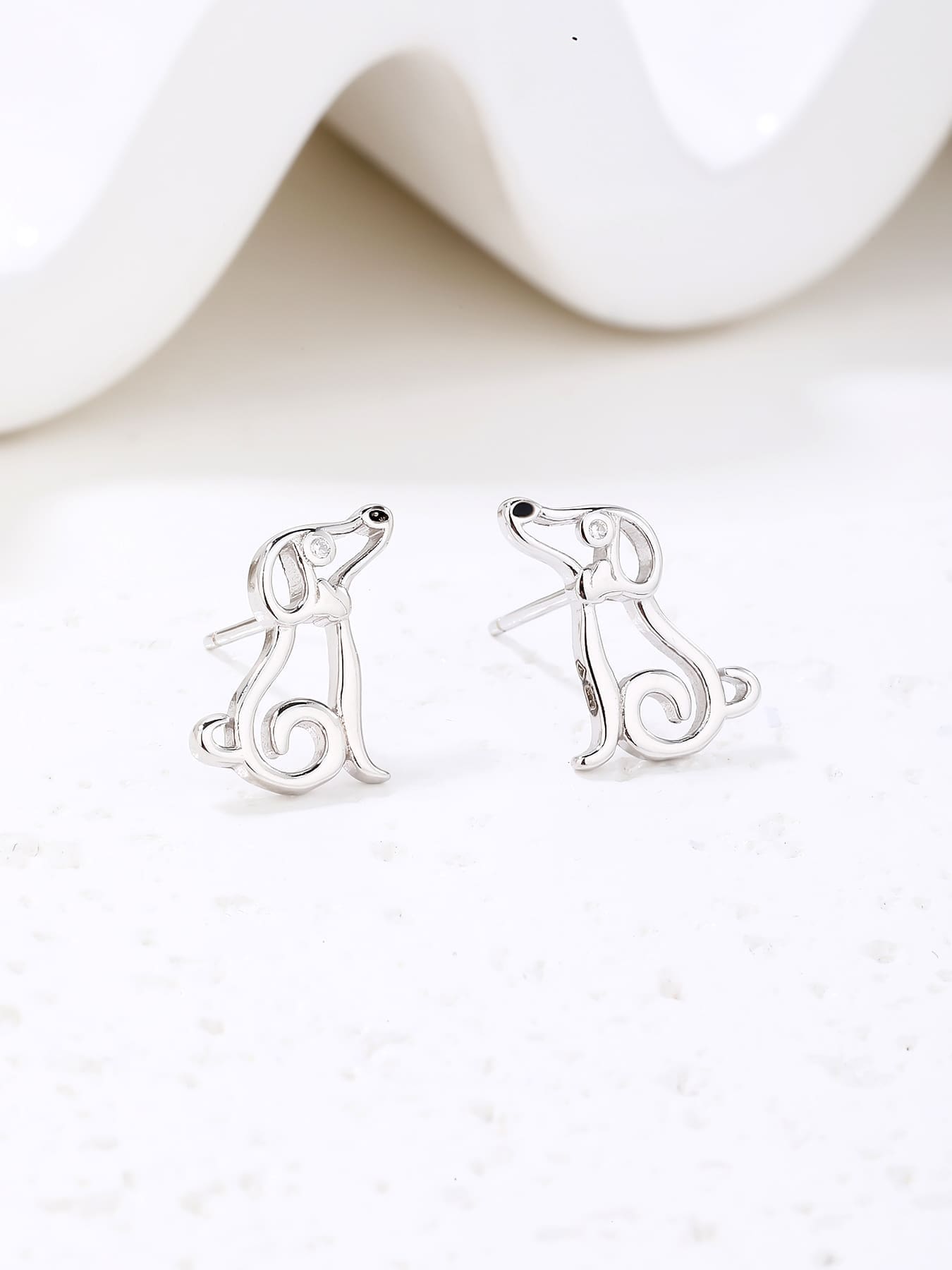 Dog-shaped stud earrings with cubic zirconia eyes in hallmarked, rhodium-plated 925 sterling silver – display view – DRESCHER Jewellery®