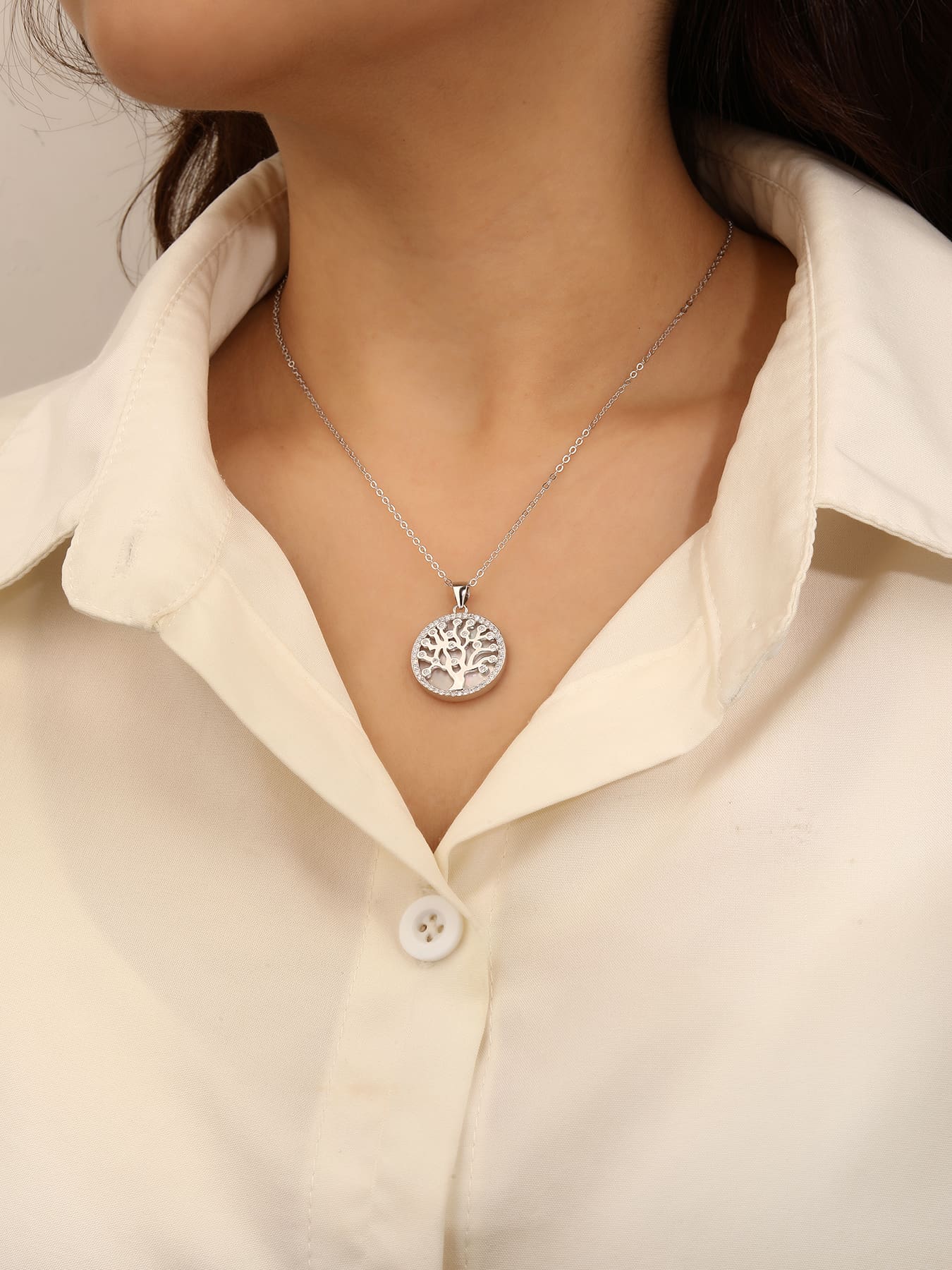 Tree of Life pendant with cubic zirconia decoration and mother-of-pearl inlay, crafted with hallmarked, rhodium-plated 925 sterling silver – worn view – DRESCHER Jewellery®