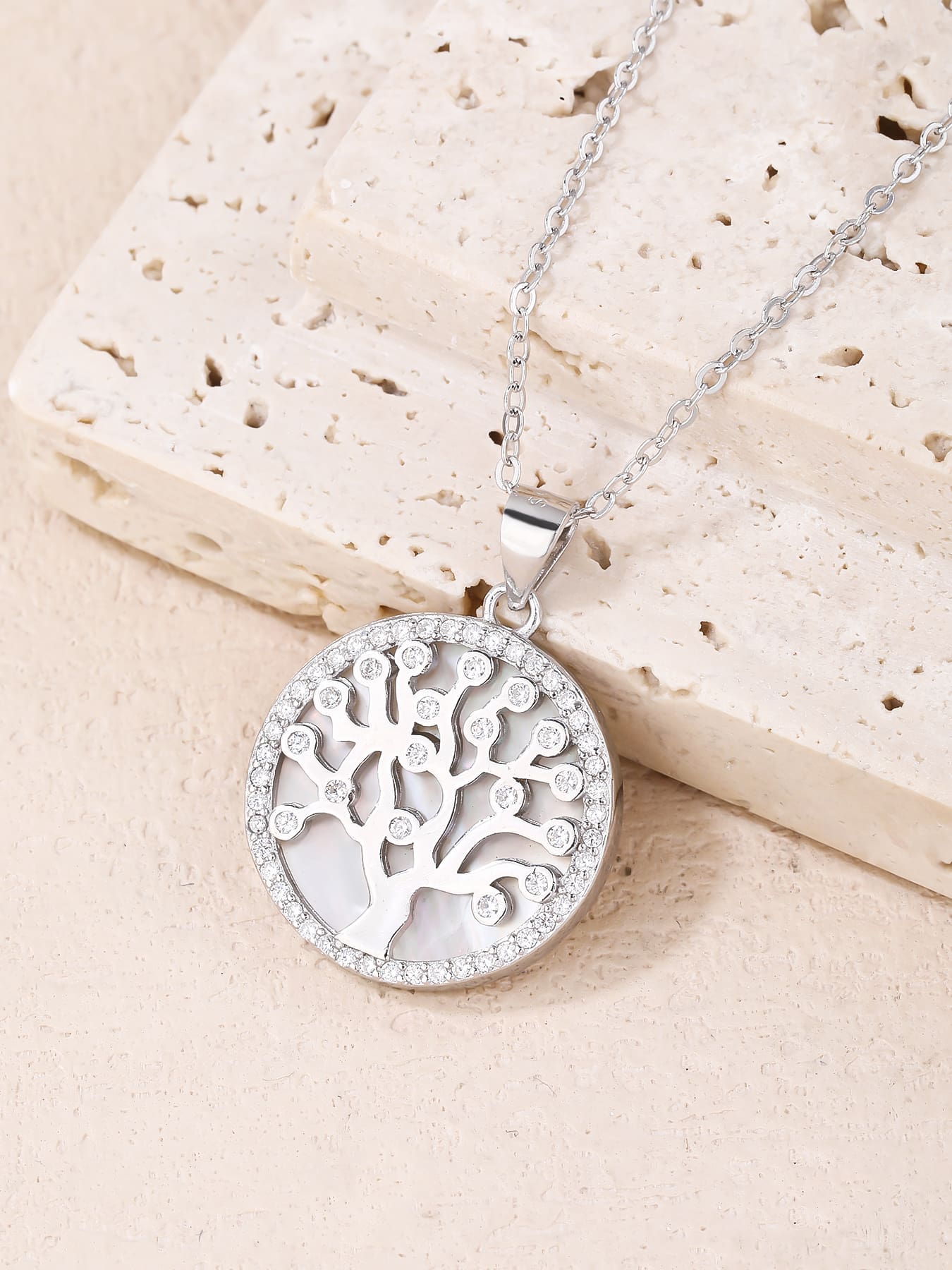 Tree of Life pendant with cubic zirconia decoration and mother-of-pearl inlay, crafted with hallmarked, rhodium-plated 925 sterling silver – lifestyle view – DRESCHER Jewellery®