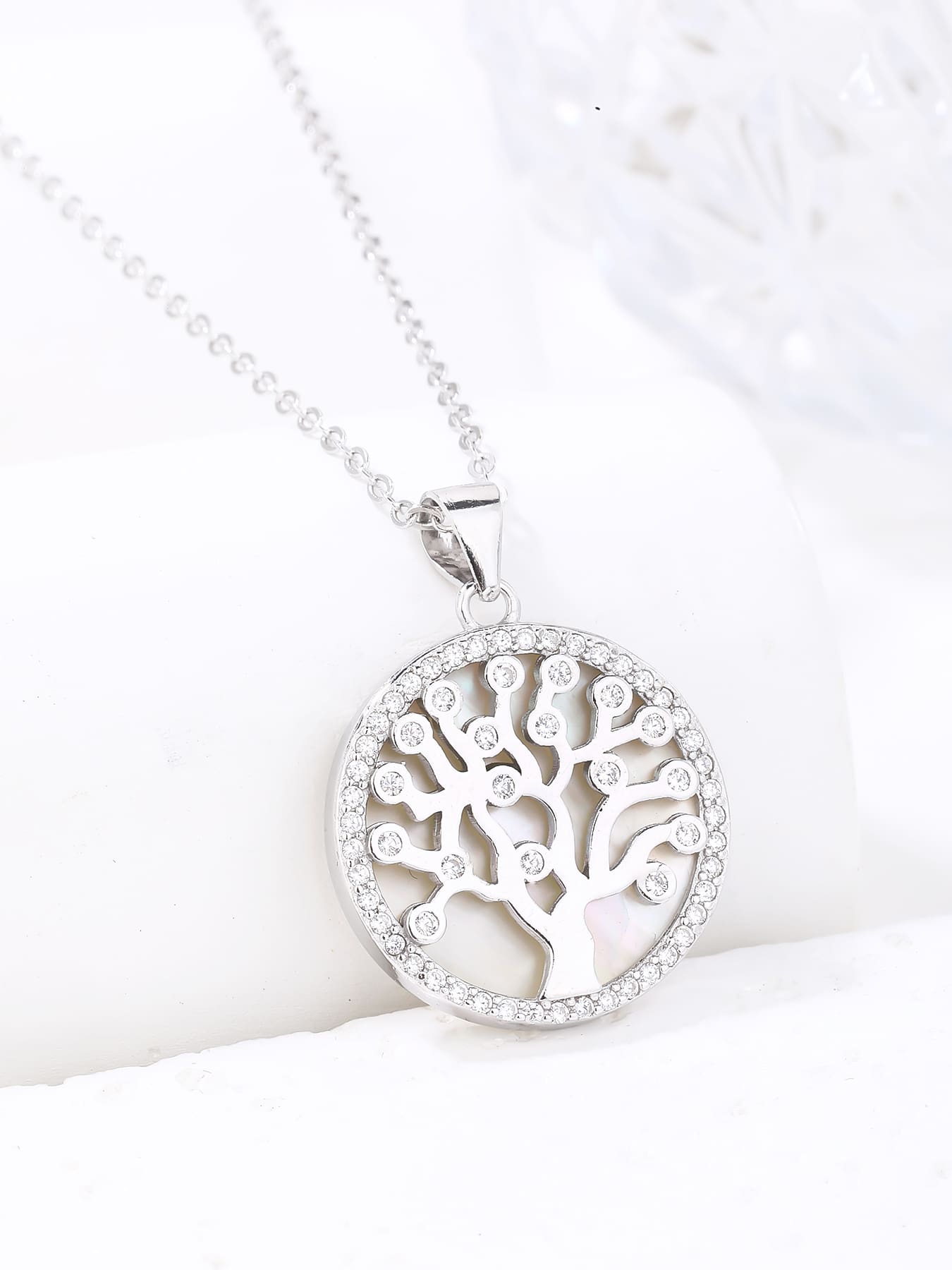 Tree of Life pendant with cubic zirconia decoration and mother-of-pearl inlay, crafted with hallmarked, rhodium-plated 925 sterling silver – display view – DRESCHER Jewellery®