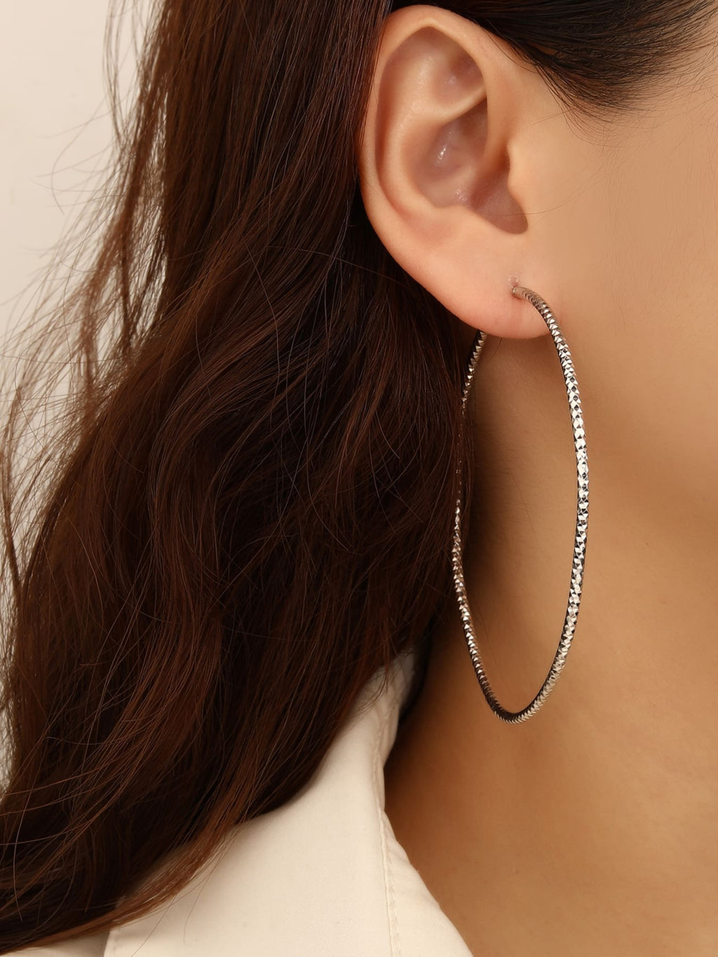 Large diamond-cut hoop earrings in hallmarked, rhodium-plated 925 sterling silver – worn view – DRESCHER Jewellery®
