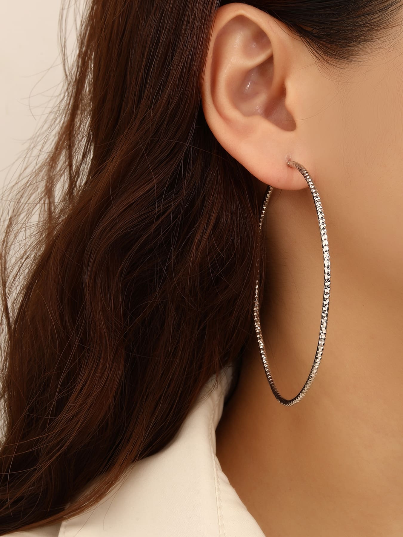 Large diamond-cut hoop earrings in hallmarked, rhodium-plated 925 sterling silver – worn view – DRESCHER Jewellery®