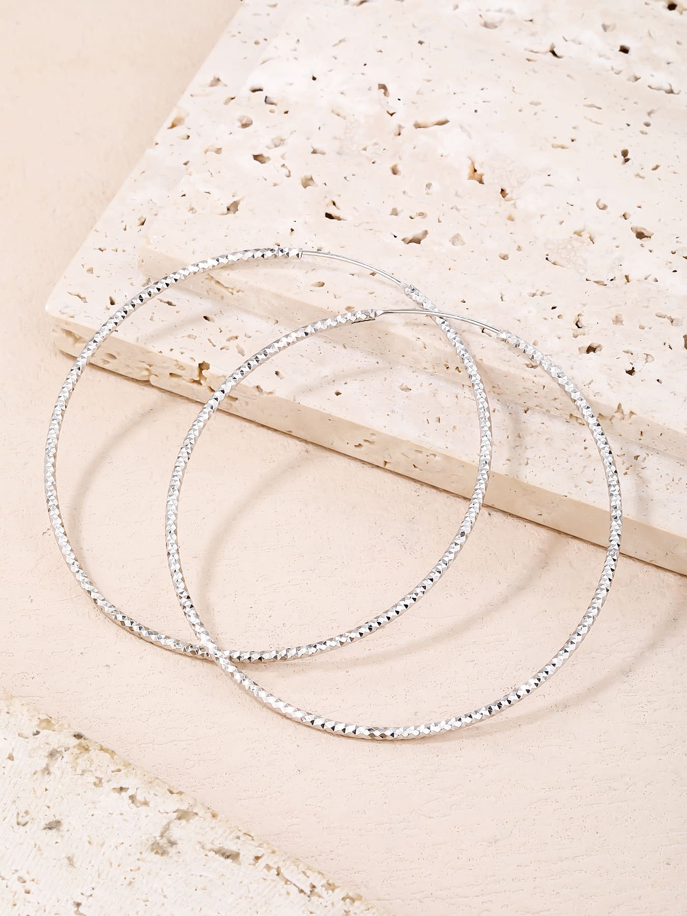 Large diamond-cut hoop earrings in hallmarked, rhodium-plated 925 sterling silver – display view – DRESCHER Jewellery®