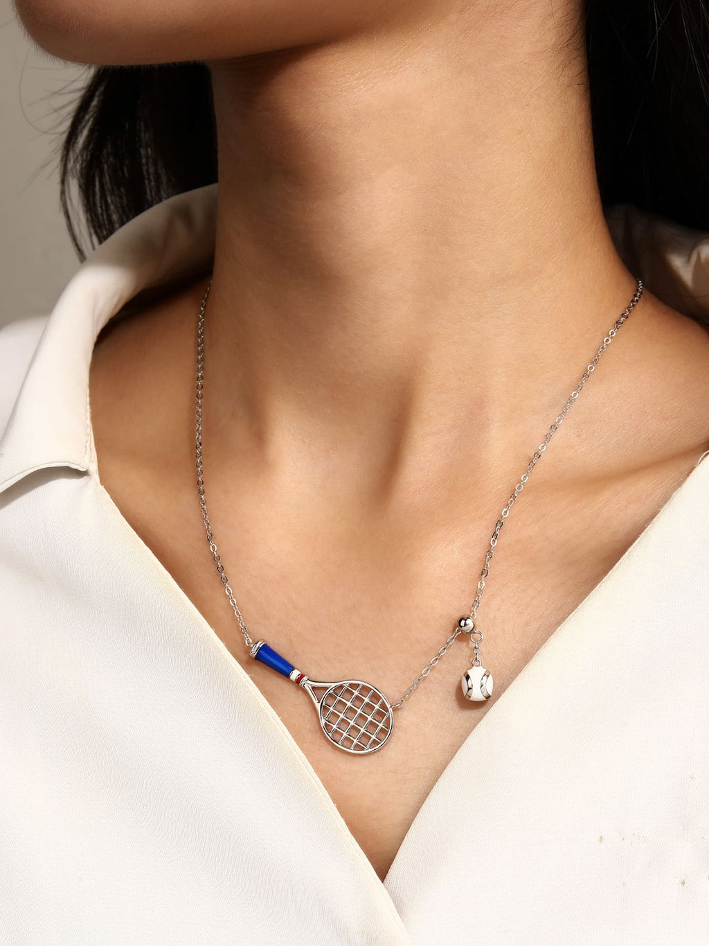 necklace with tennis racket and ball pendant in hallmarked, rhodium-plated 925 sterling silver – worn view – DRESCHER Jewellery®