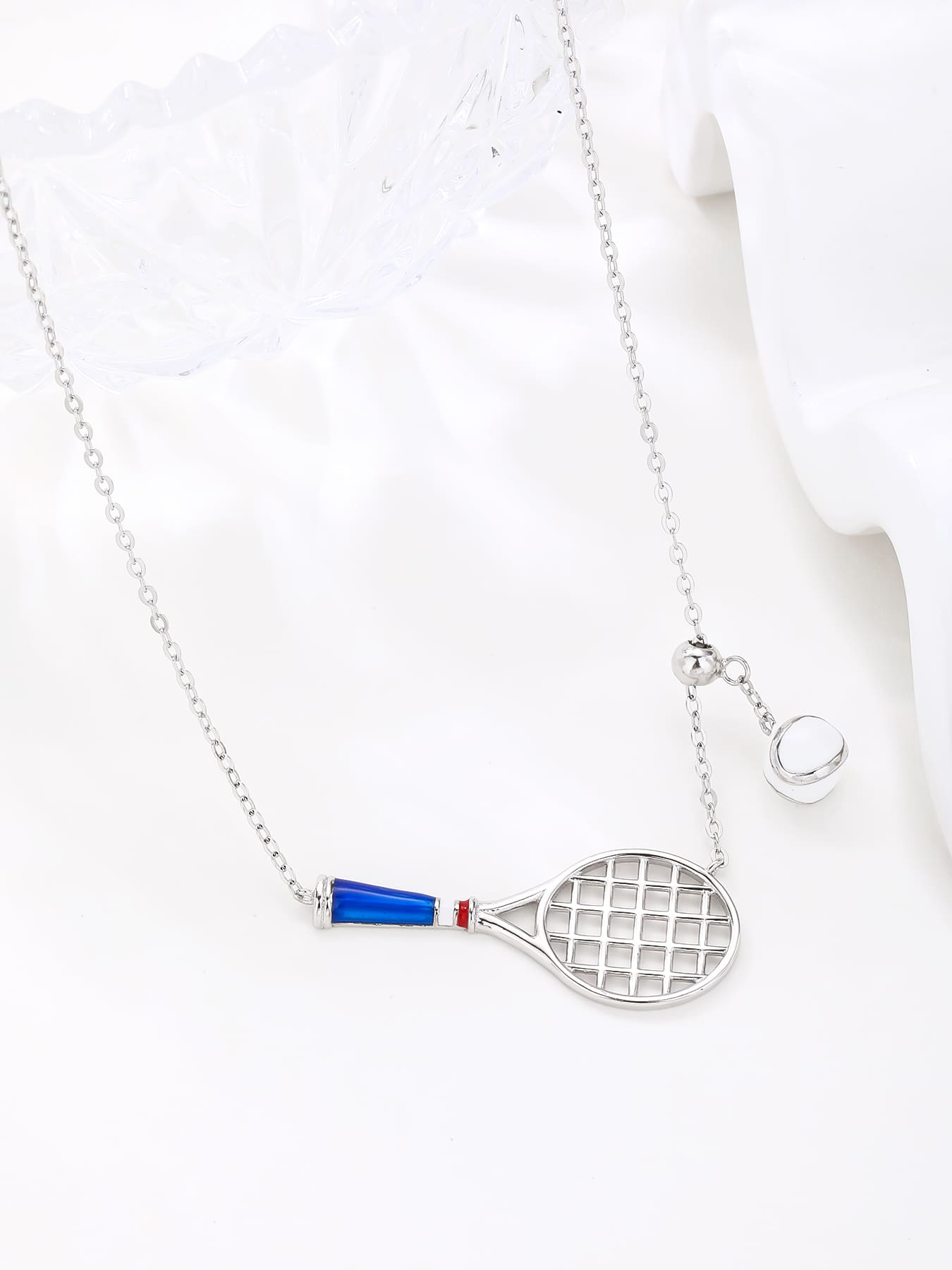 necklace with tennis racket and ball pendant in hallmarked, rhodium-plated 925 sterling silver – detail view – DRESCHER Jewellery®