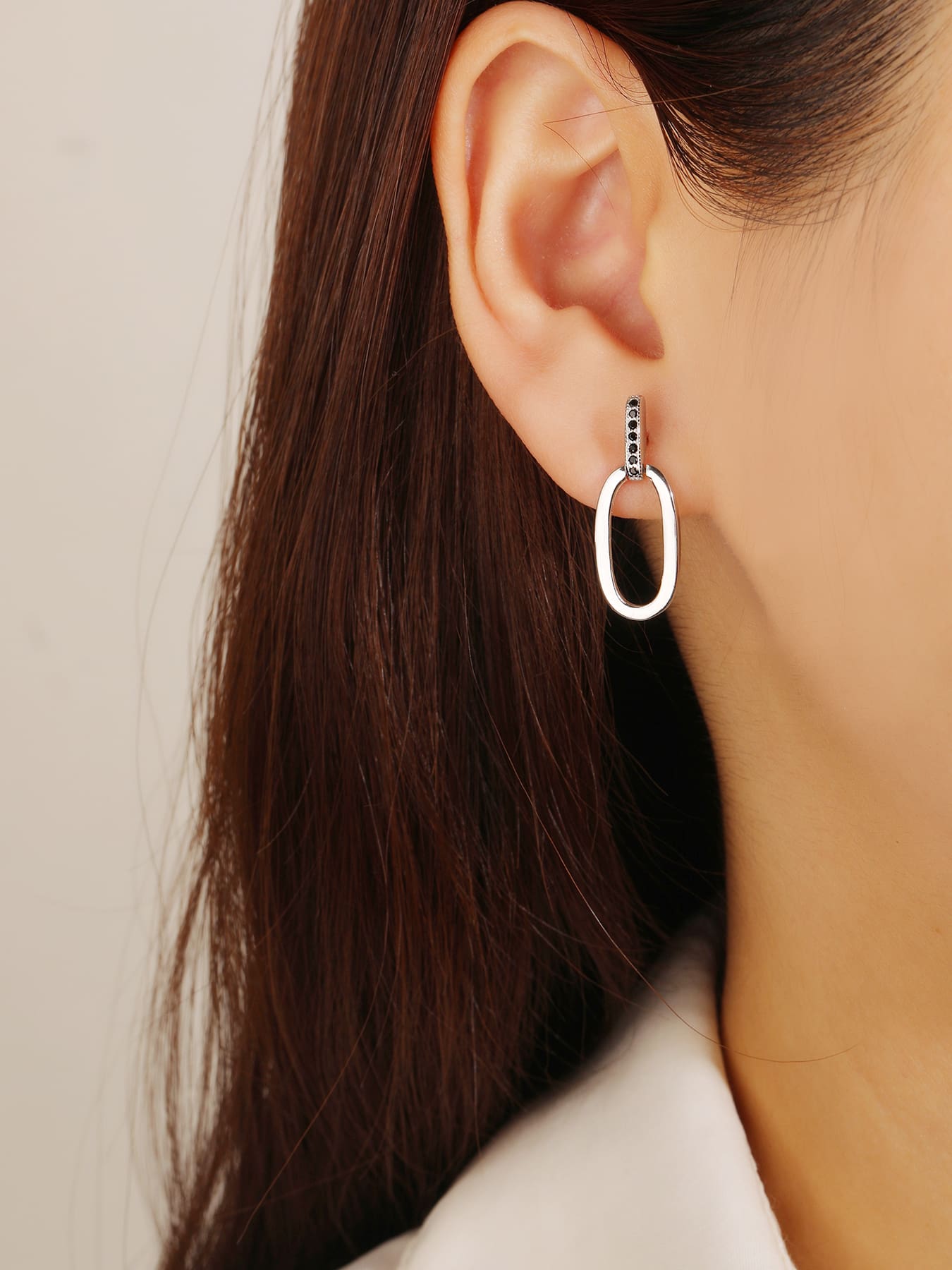 Black zirconia oval dangle earrings in hallmarked, rhodium-plated 925 sterling silver – worn view – DRESCHER Jewellery®
