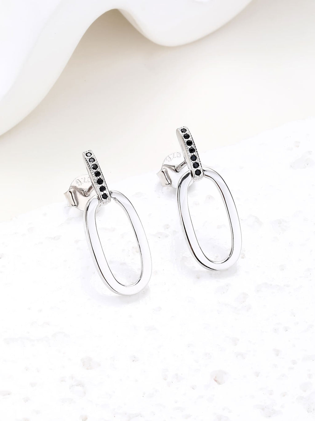 Black zirconia oval dangle earrings in hallmarked, rhodium-plated 925 sterling silver – display view – DRESCHER Jewellery®