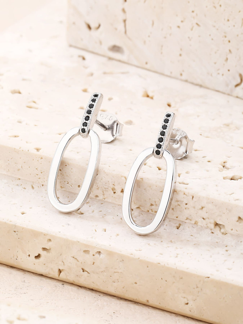 Black zirconia oval dangle earrings in hallmarked, rhodium-plated 925 sterling silver – lifestyle view – DRESCHER Jewellery®