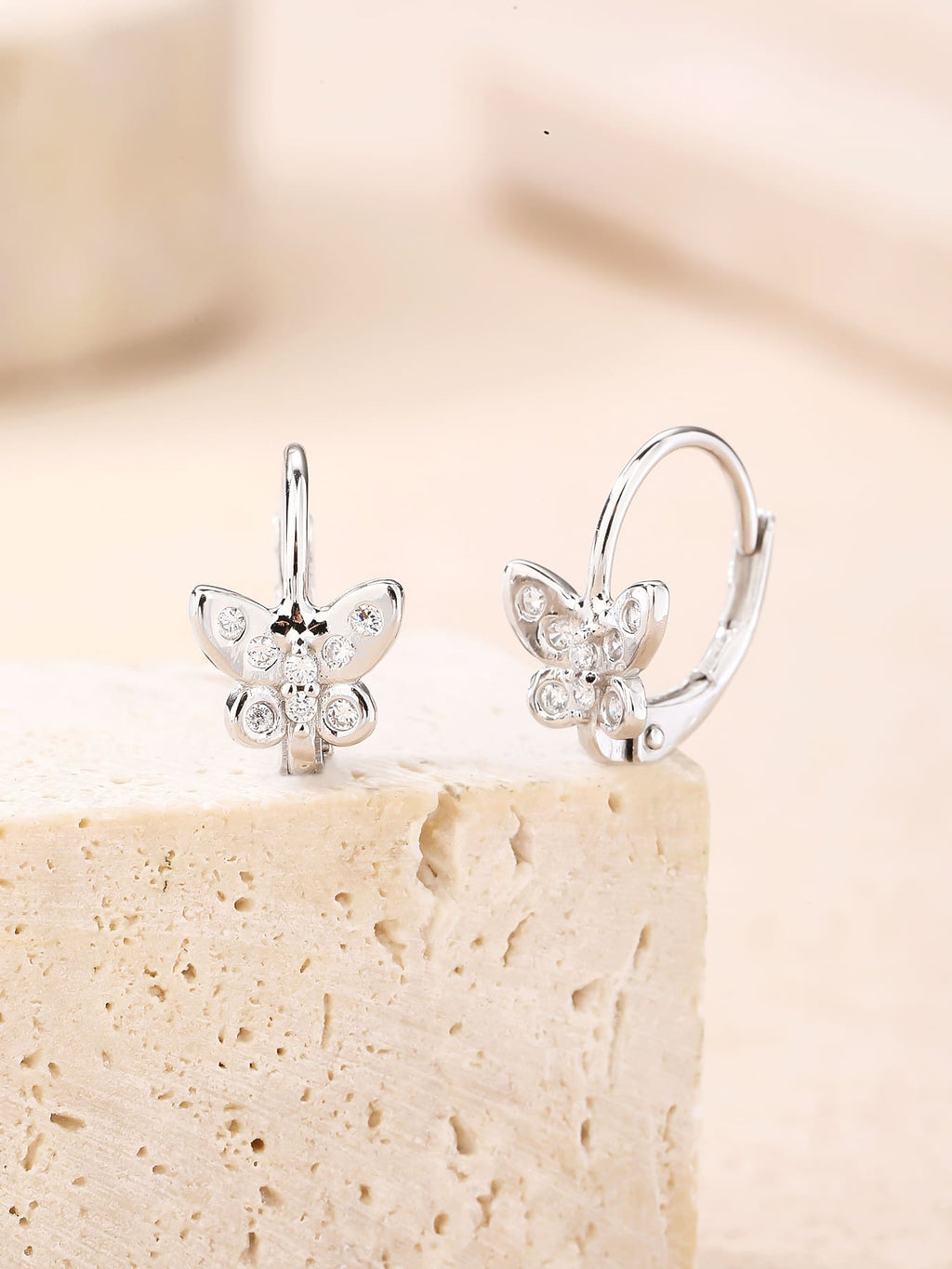 White cubic zirconia butterfly leverback earrings in hallmarked, rhodium-plated 925 sterling silver – display view – DRESCHER Jewellery®