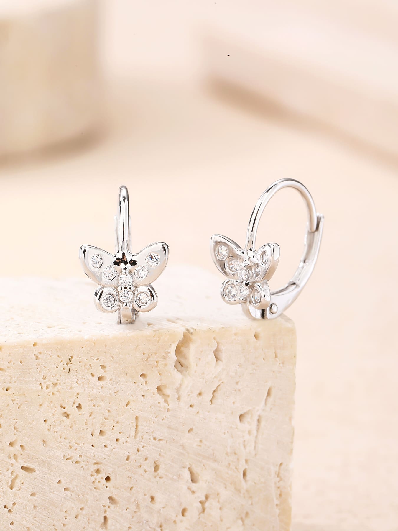 White cubic zirconia butterfly leverback earrings in hallmarked, rhodium-plated 925 sterling silver – display view – DRESCHER Jewellery®