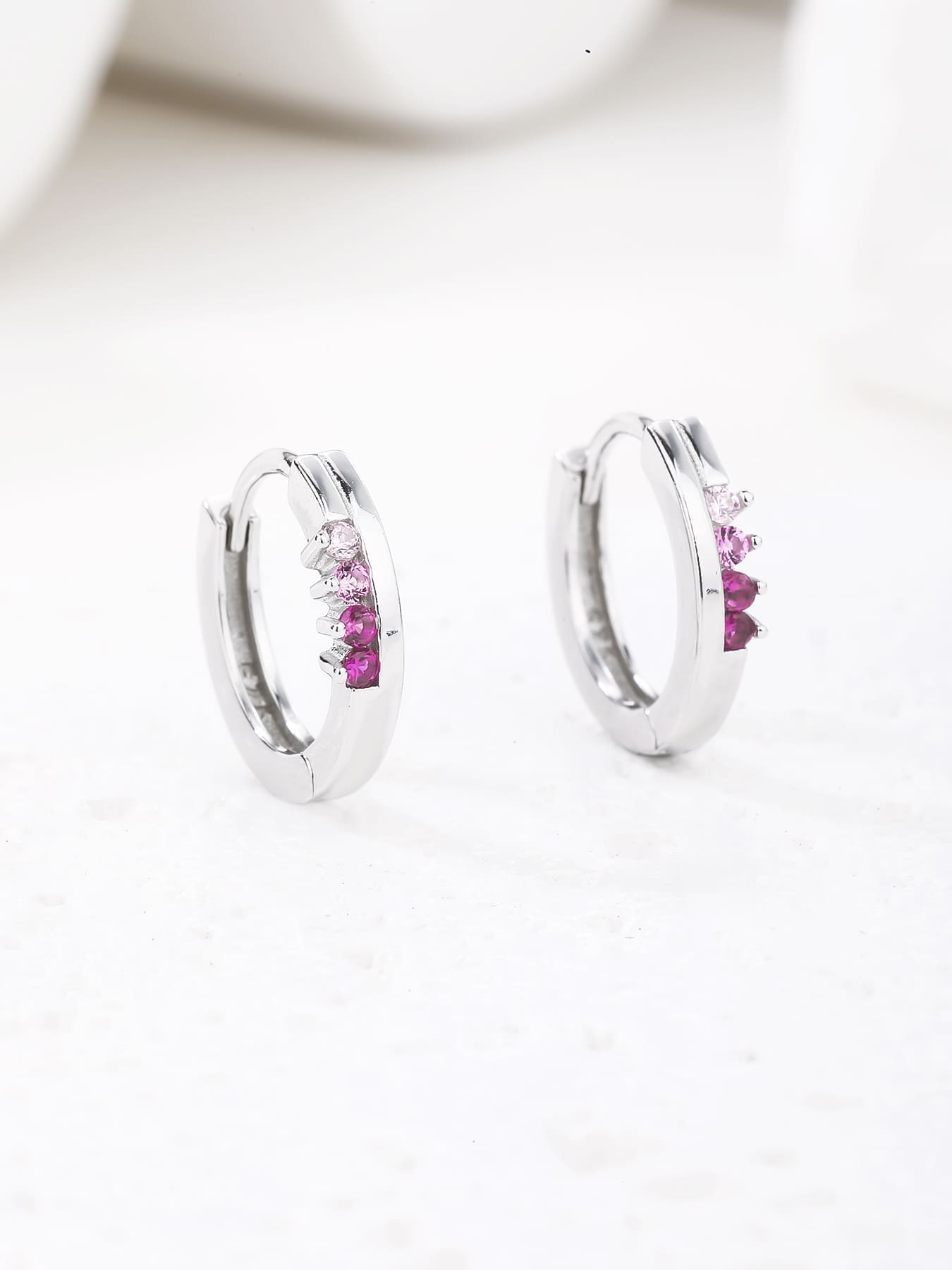 pink - red and pink cubic zirconia stone hoop earrings in hallmarked, rhodium-plated 925 sterling silver – lifestyle view – DRESCHER Jewellery®