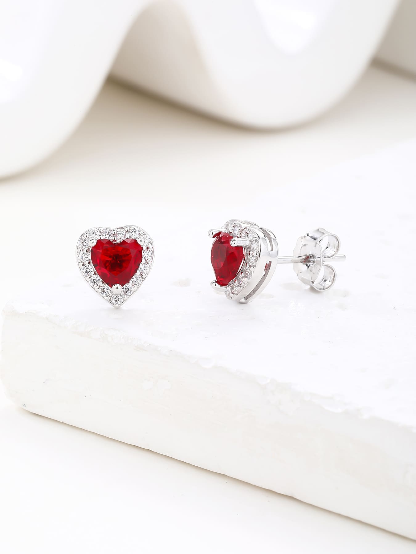 Red heart and white cubic zirconia stud earrings in hallmarked, rhodium-plated 925 sterling silver – display view – DRESCHER Jewellery®