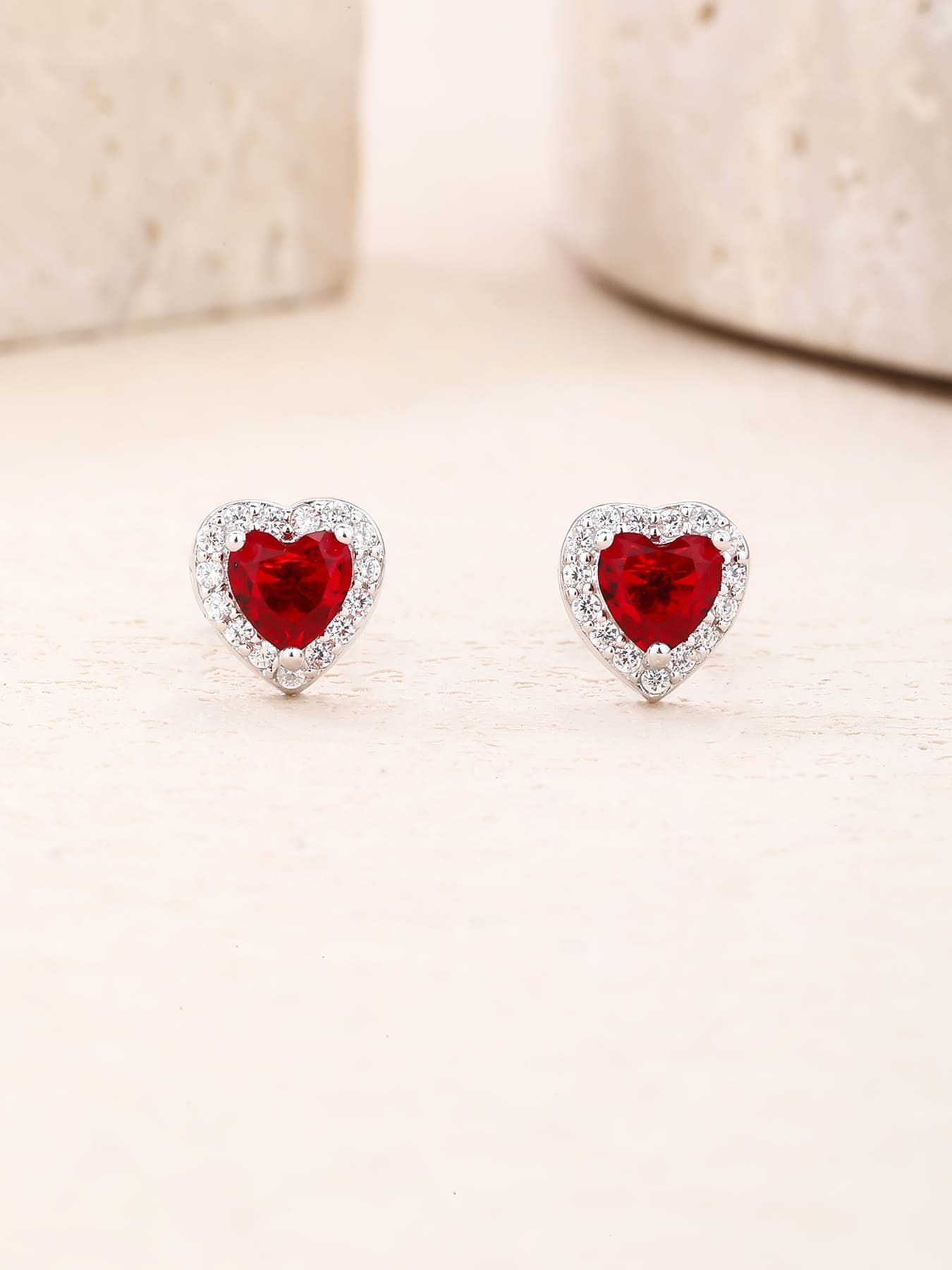 Red heart and white cubic zirconia stud earrings in hallmarked, rhodium-plated 925 sterling silver – display view – DRESCHER Jewellery®