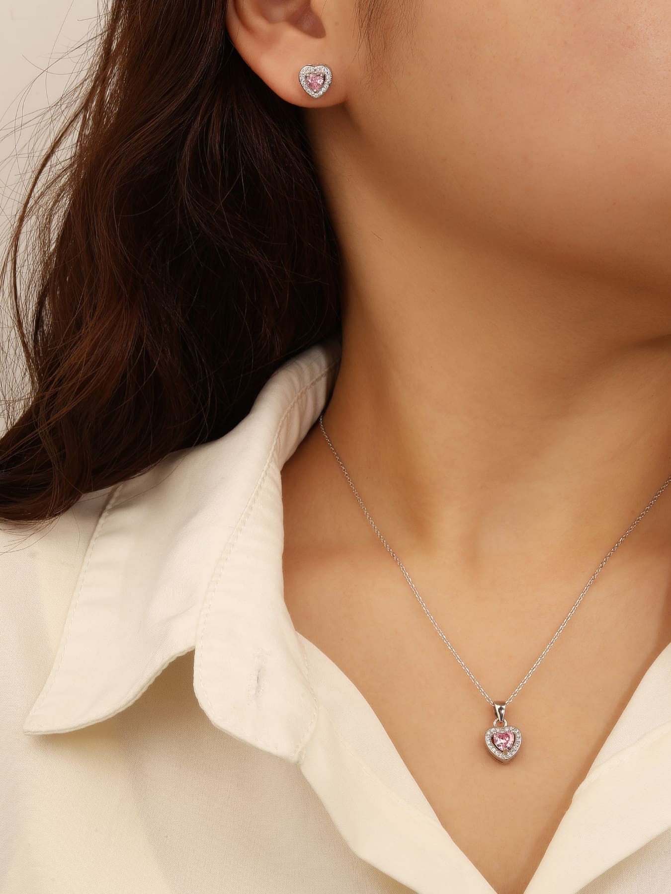 pink heart shaped zirconia stud earrings and pendant set in hallmarked, rhodium-plated 925 sterling silver – worn view – DRESCHER Jewellery®