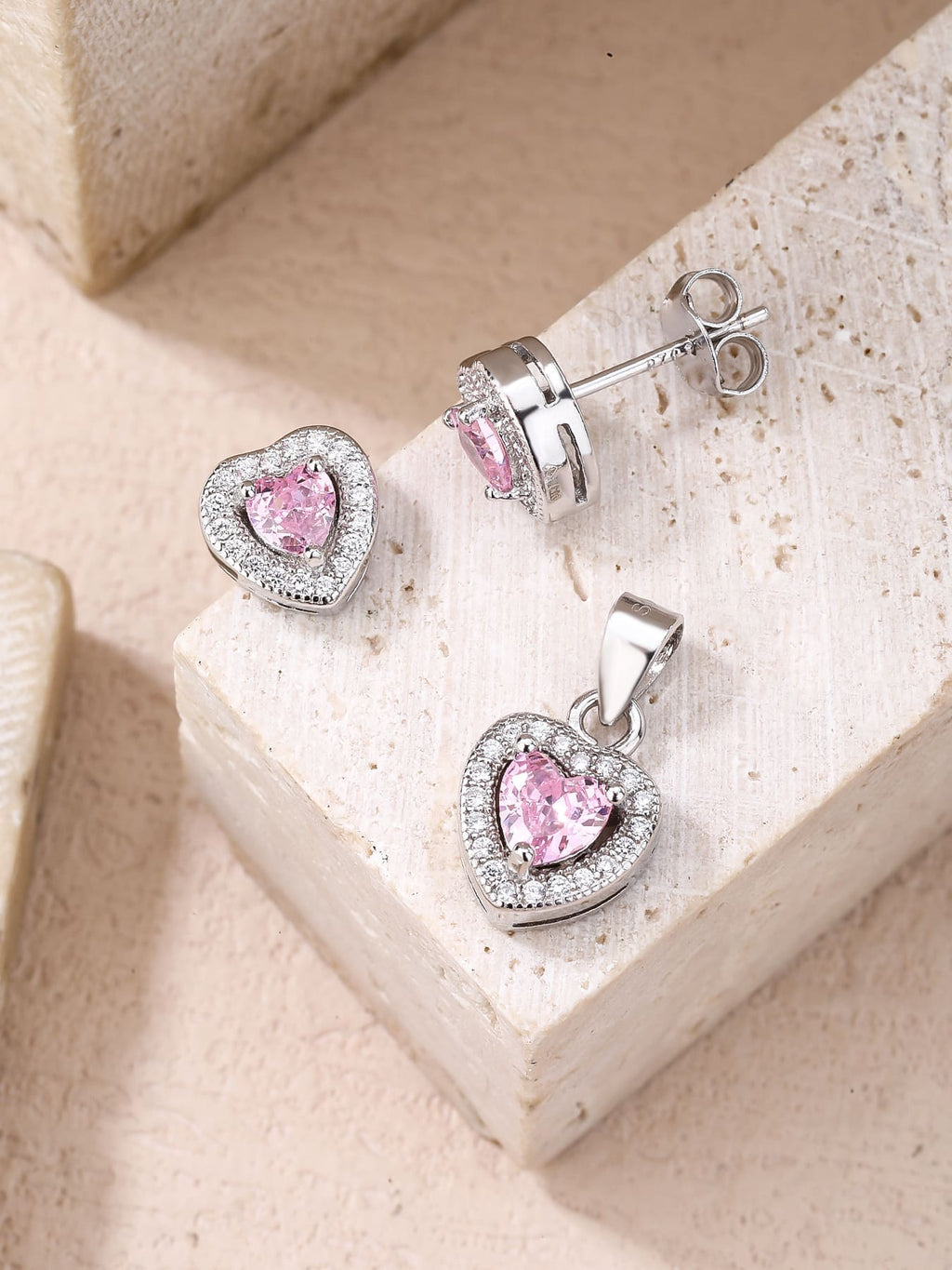 pink heart shaped zirconia stud earrings and pendant set in hallmarked, rhodium-plated 925 sterling silver – lifestyle view – DRESCHER Jewellery®