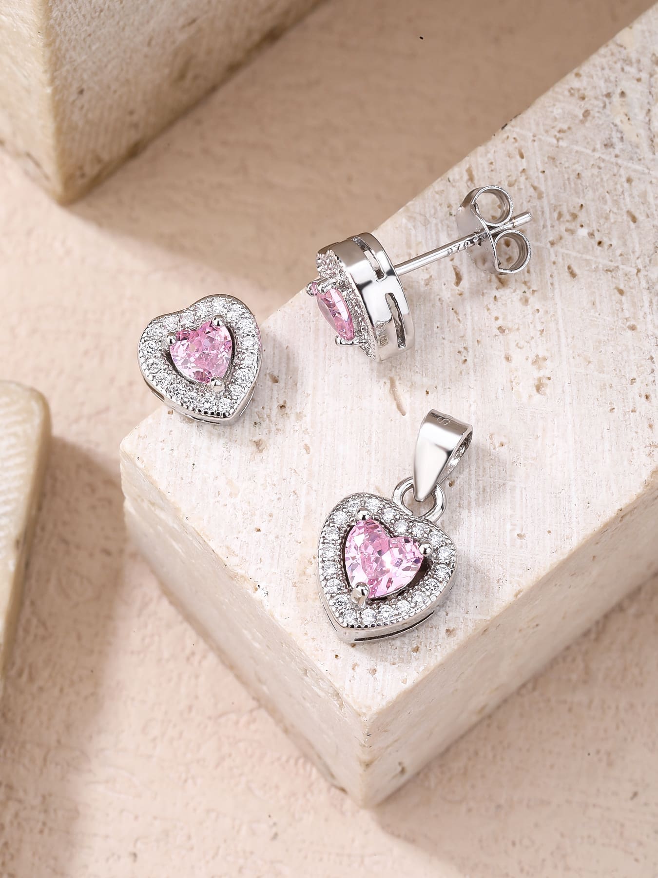 pink heart shaped zirconia stud earrings and pendant set in hallmarked, rhodium-plated 925 sterling silver – lifestyle view – DRESCHER Jewellery®