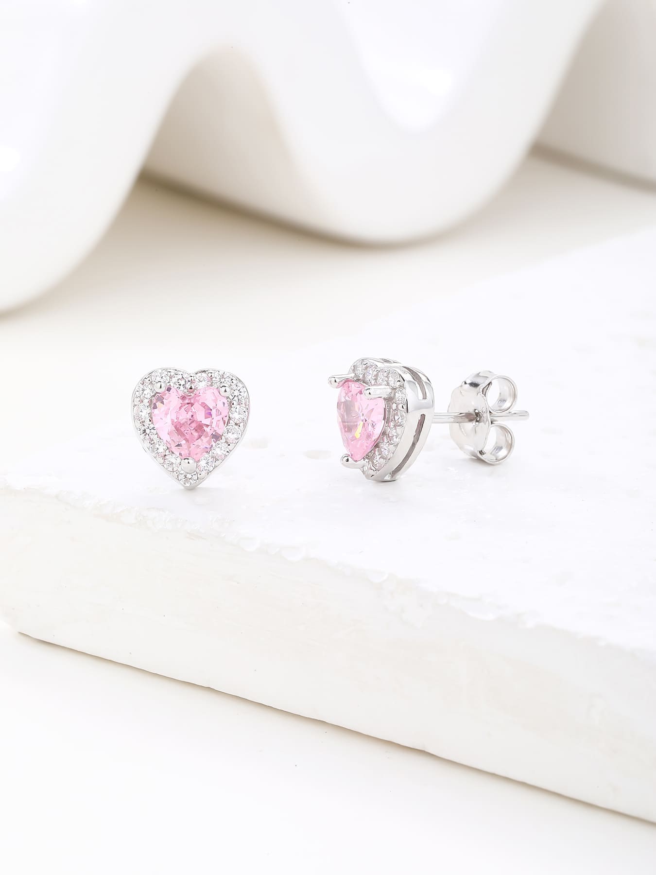 Pink heart and white cubic zirconia stud earrings in hallmarked, rhodium-plated 925 sterling silver – display view – DRESCHER Jewellery®