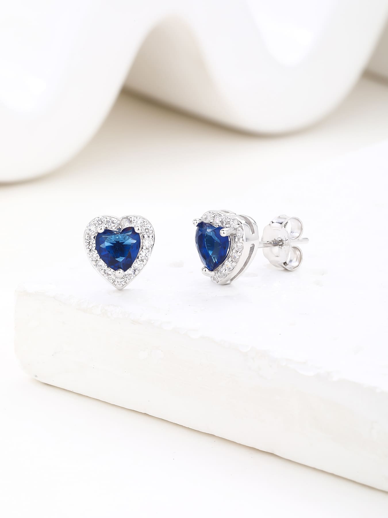 Dark blue heart and white cubic zirconia halo stud earrings in hallmarked, rhodium-plated 925 sterling silver – display view – DRESCHER Jewellery®