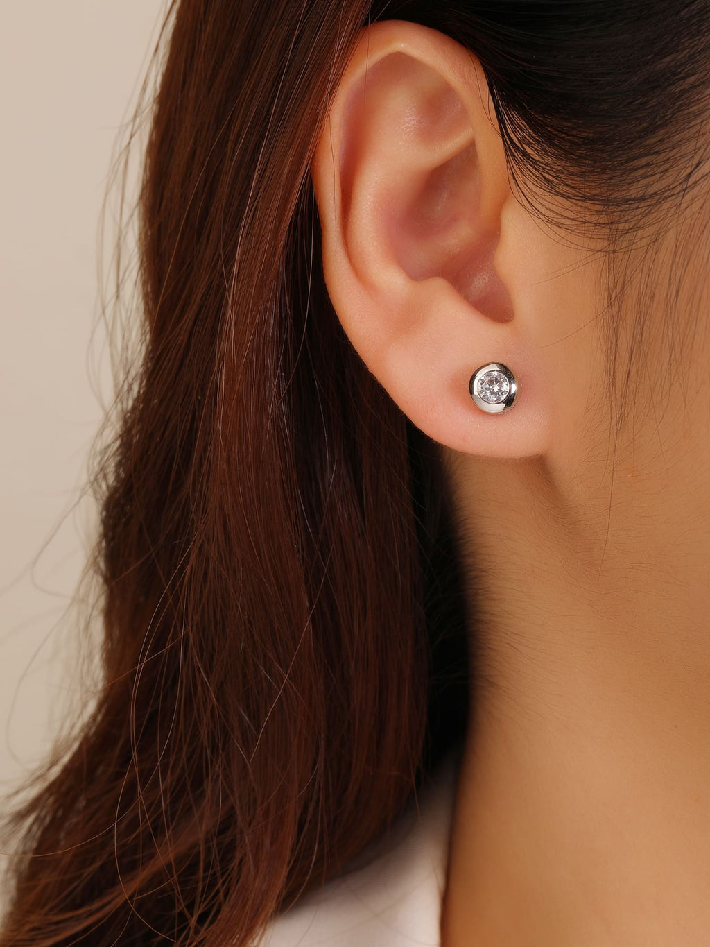 White cubic zirconia button-set stud earrings in hallmarked, rhodium-plated 925 sterling silver – worn view – DRESCHER Jewellery®